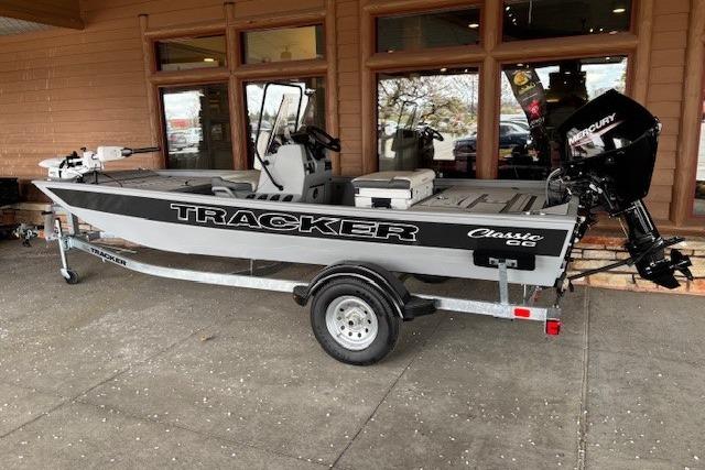 2026 Tracker Bass Tracker Classic CC boat on trailer, parked outside a building.