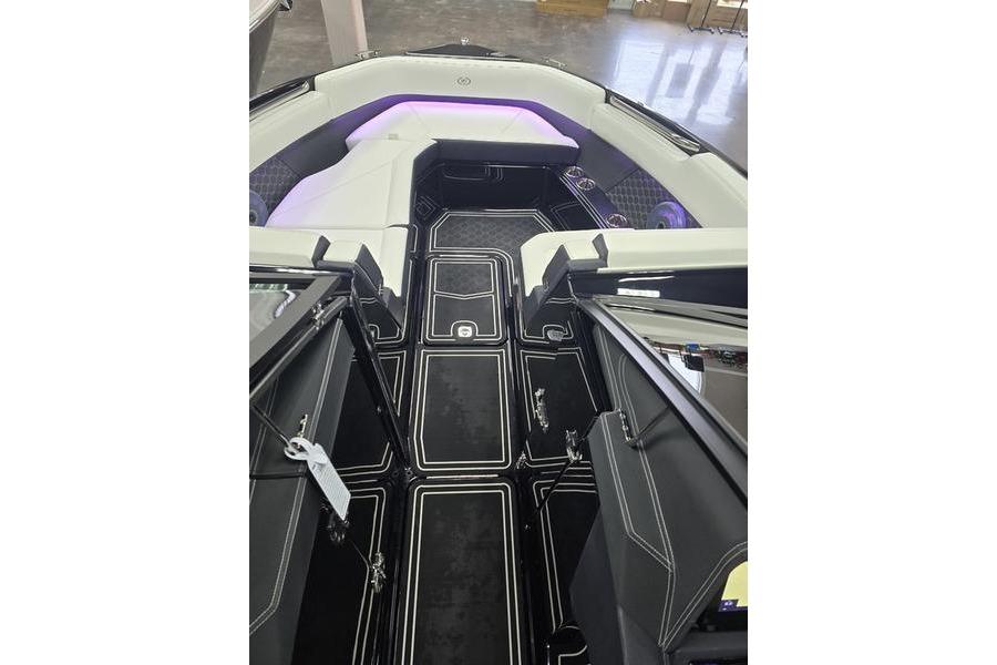 2026 Cobalt R8 Surf boat interior with sleek black flooring and modern seating.