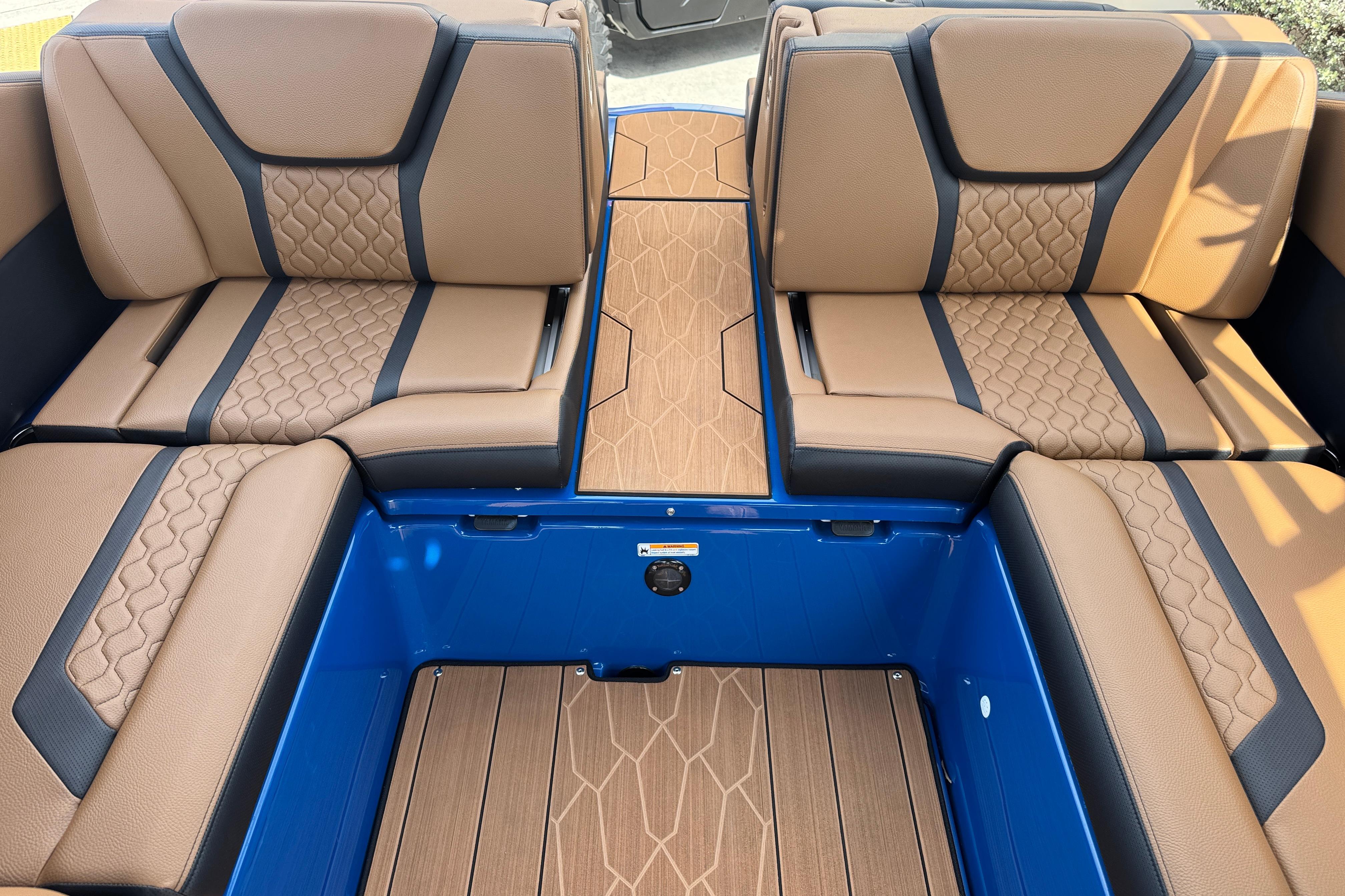 Luxurious interior seating of 2026 Yamaha Boats 255XD, featuring elegant brown and black upholstery.