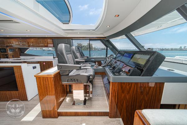 Luxurious interior of the 2025 Riviera 645 SUV yacht with advanced navigation system.