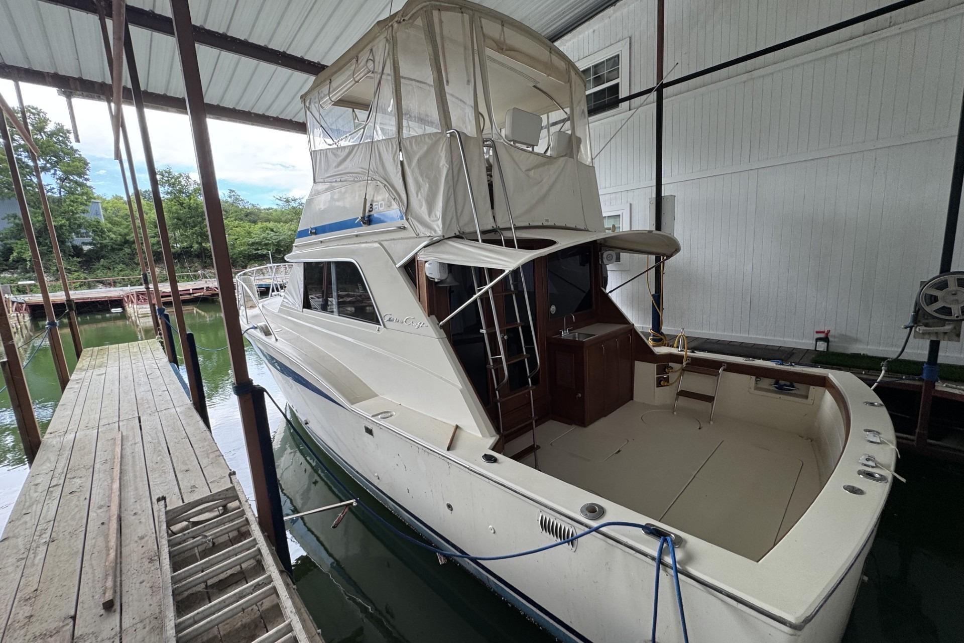 1980 Chris-Craft 360 Commander docked under a covered marina, showcasing its classic design.
