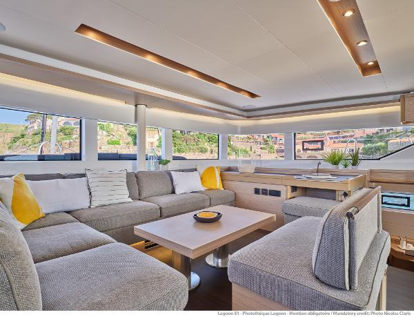Luxurious interior of 2025 Lagoon 51 ICONIC yacht with modern seating and panoramic windows.