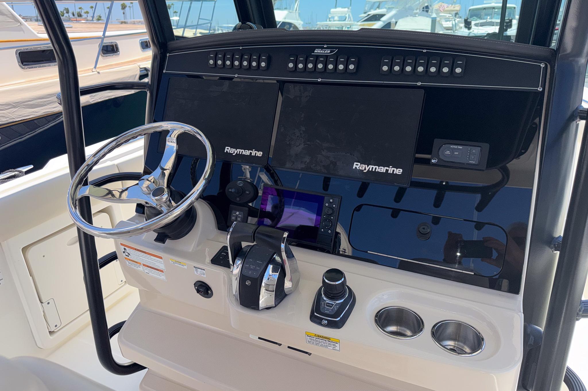 Control panel of a 2021 Boston Whaler 330 Outrage with Raymarine electronics.