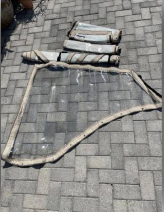 Boat canopy parts on paving stones, World Cat 246 DC, 2002.