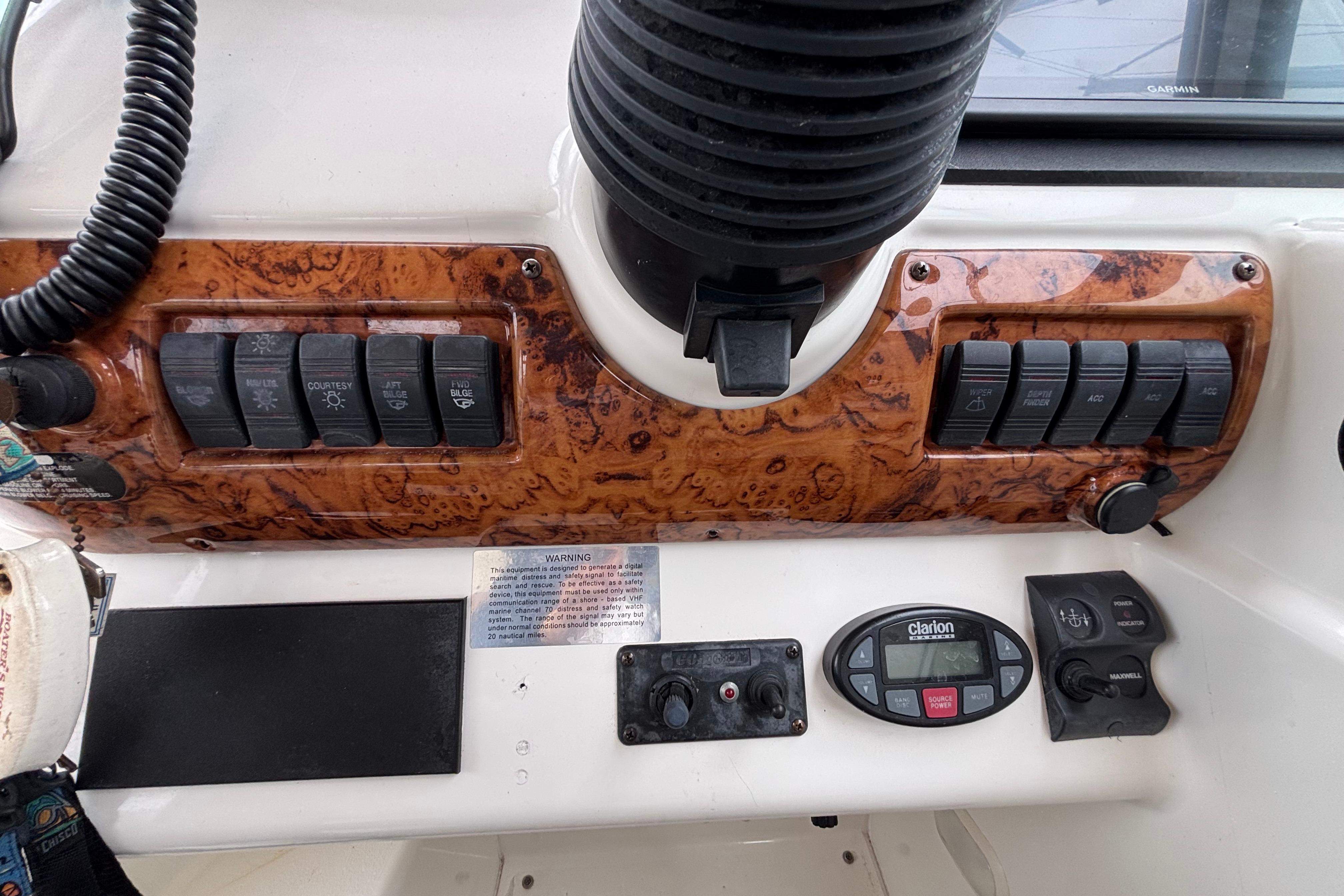 Control panel of a 2004 Larson 310 boat with switches and dials.