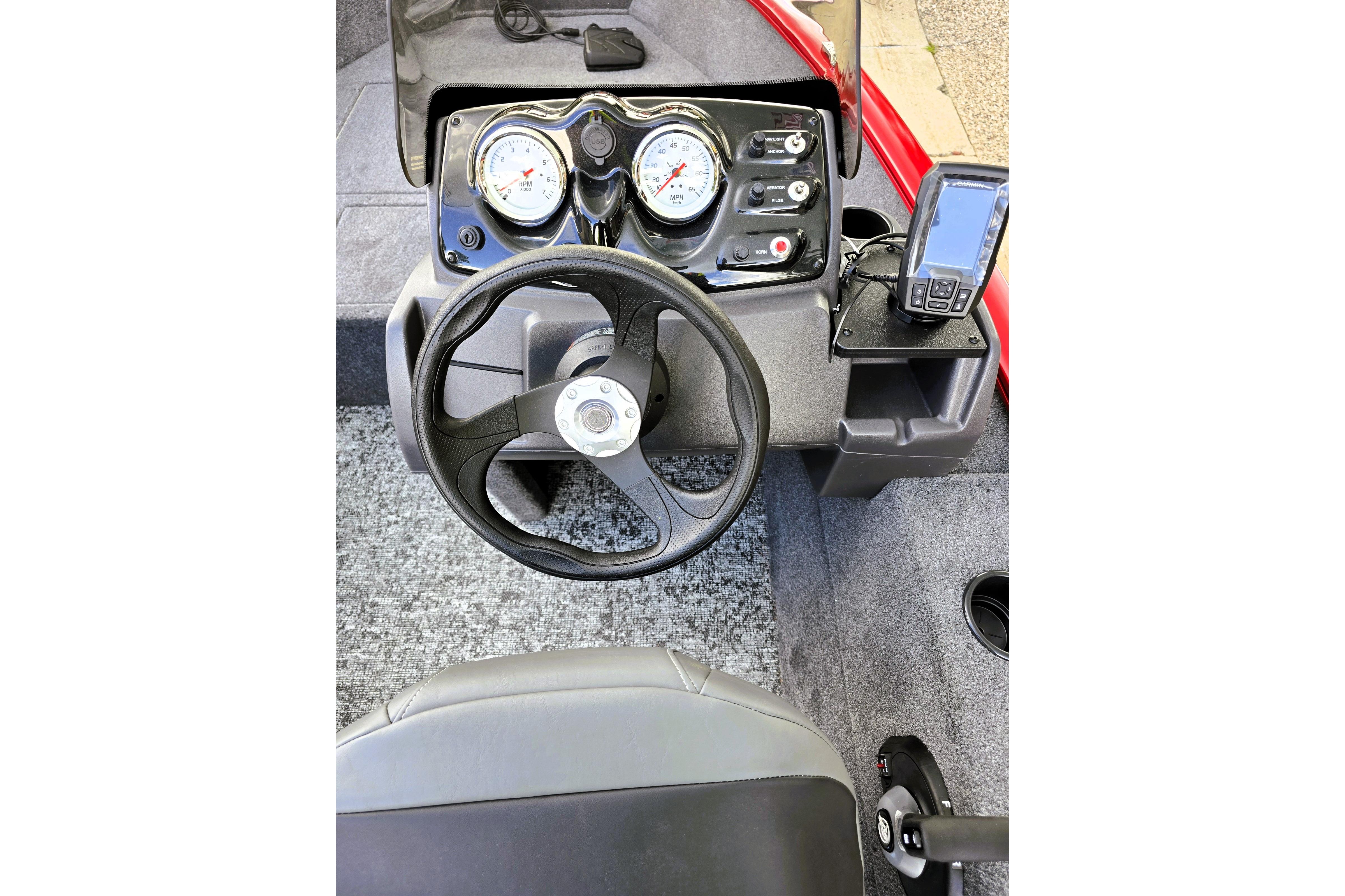 Steering console of 2026 Tracker Super Guide V-16 SC boat with gauges and navigation system.