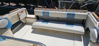 The image shows the cockpit of a 1989 Sea Ray 268 Sundancer with cushioned seating.