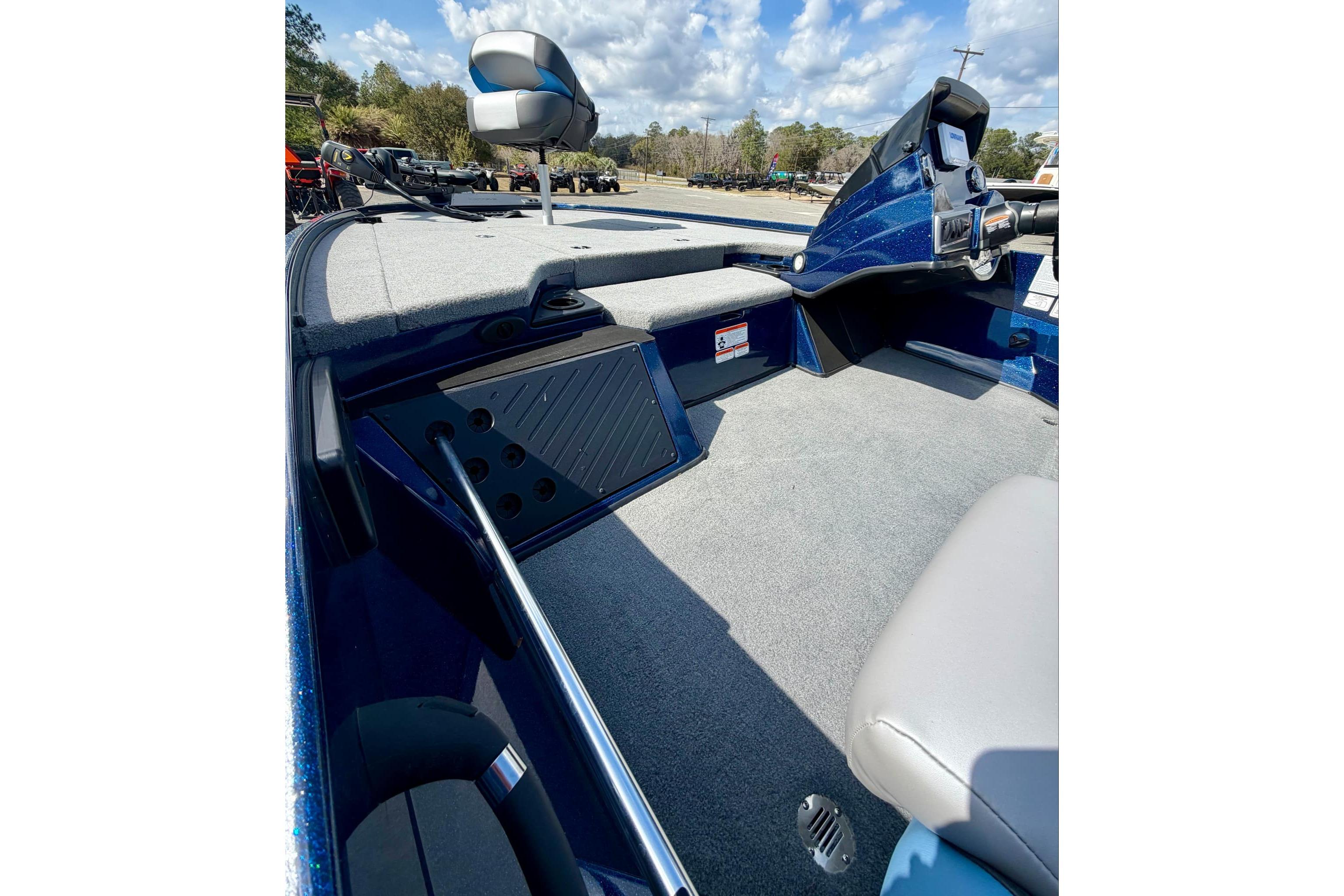 2026 Nitro Z18 boat interior with gray carpet and modern dashboard under blue sky.