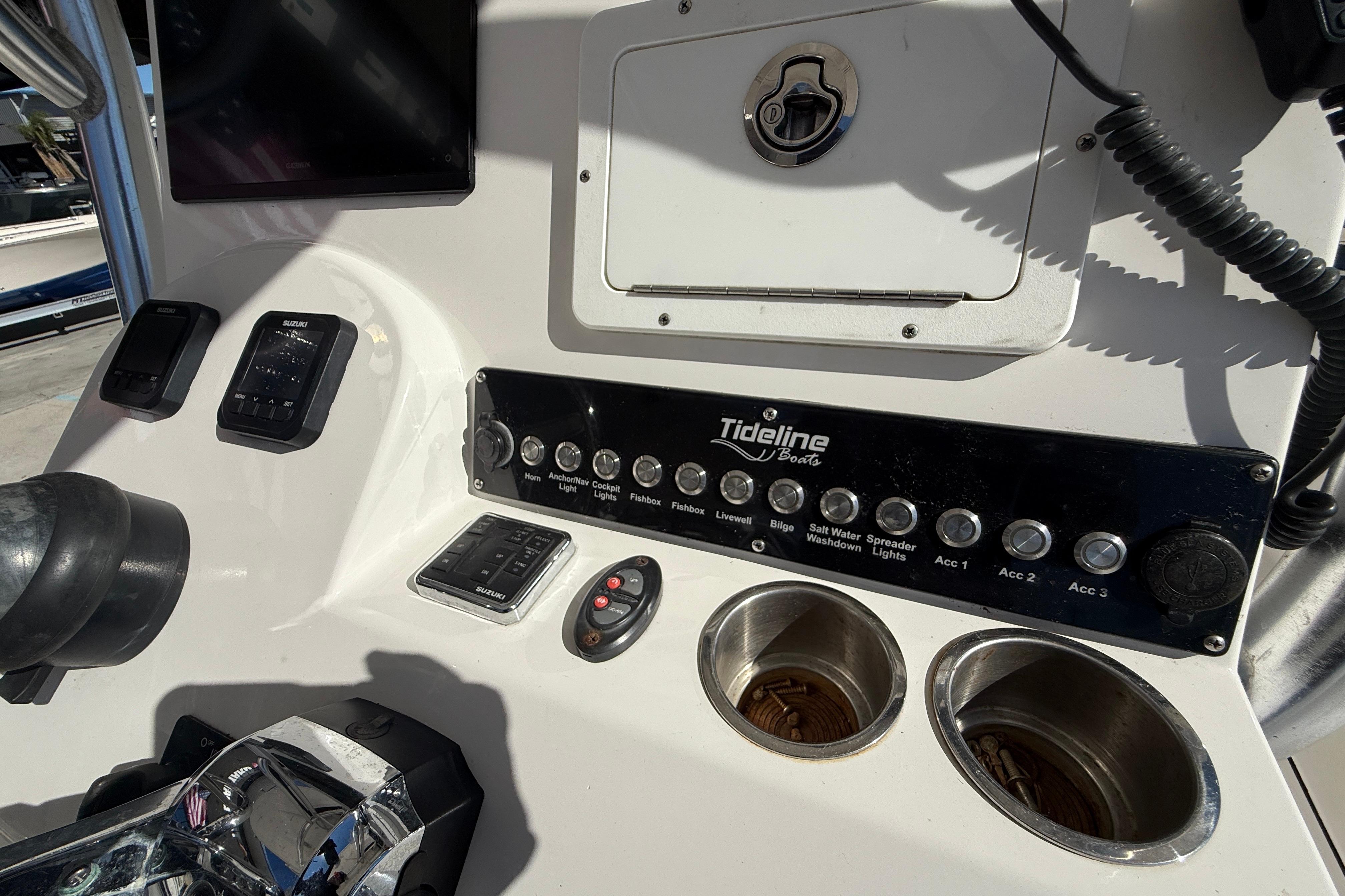 Control panel of a 2020 Tideline 235 Hybrid boat with various switches and controls.