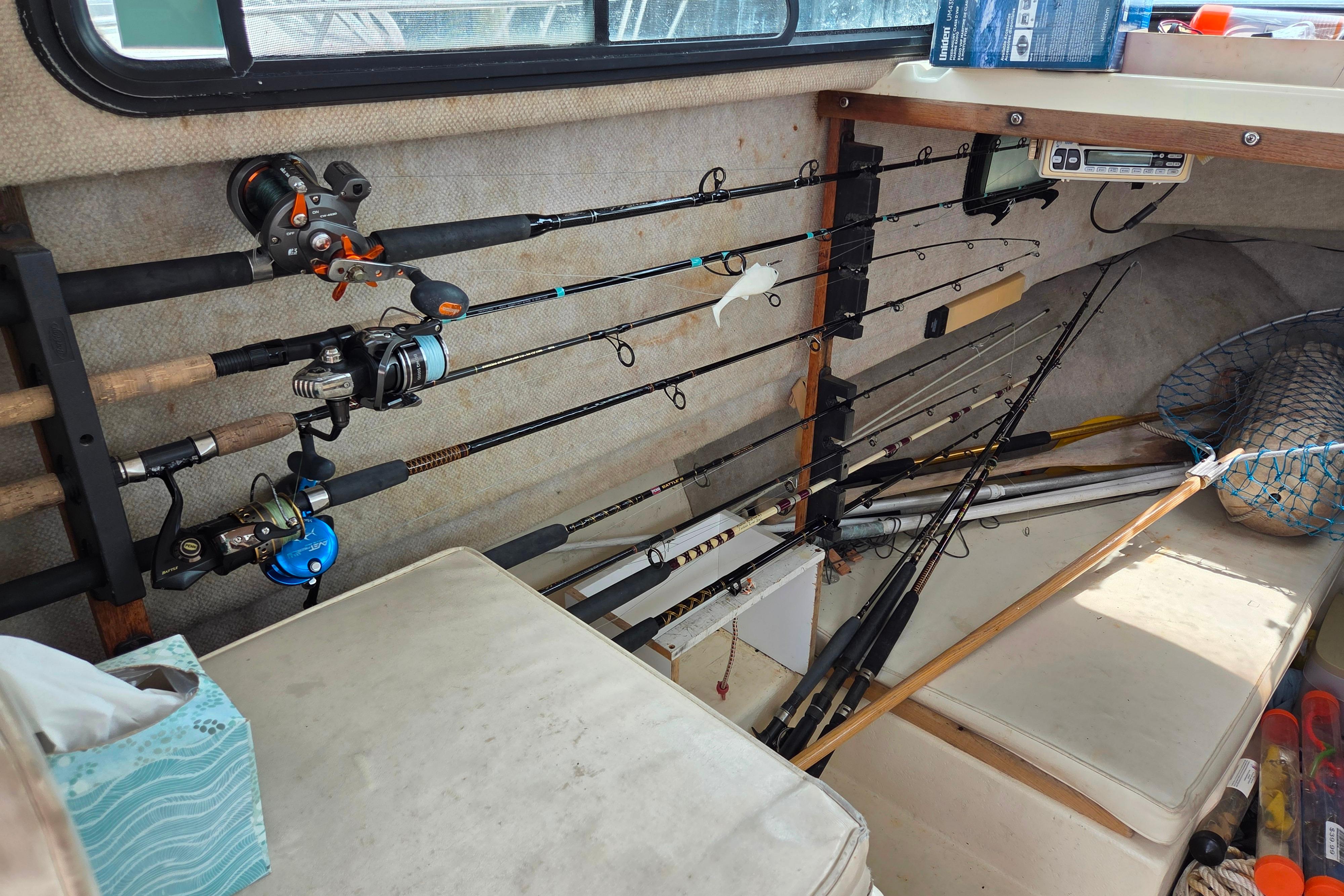 Fishing rods stored in a 2002 Parker 2520 Deep Vee Sport Cabin boat interior.