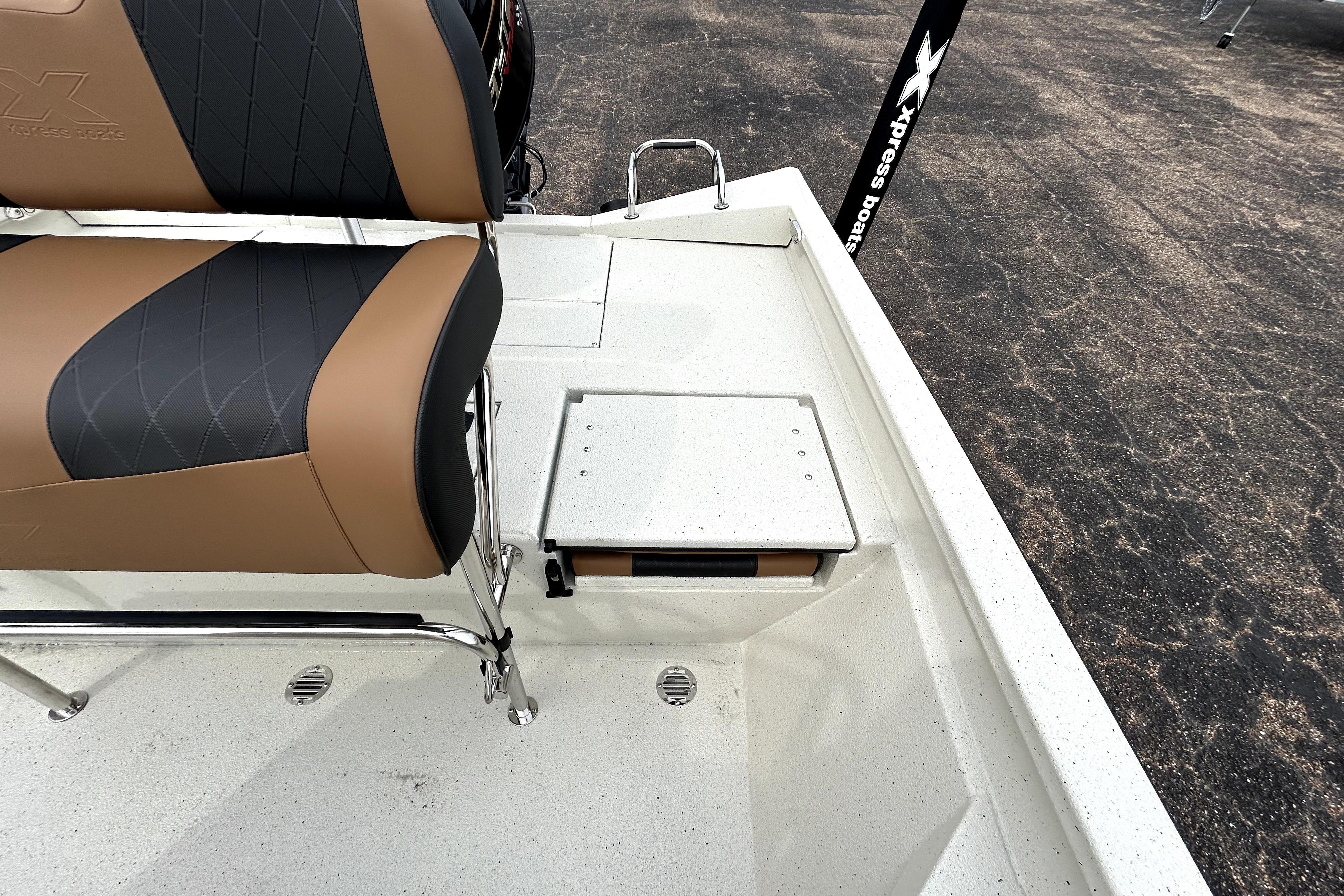 2026 Xpress H20B Bay boat interior with cushioned seating and storage compartment.