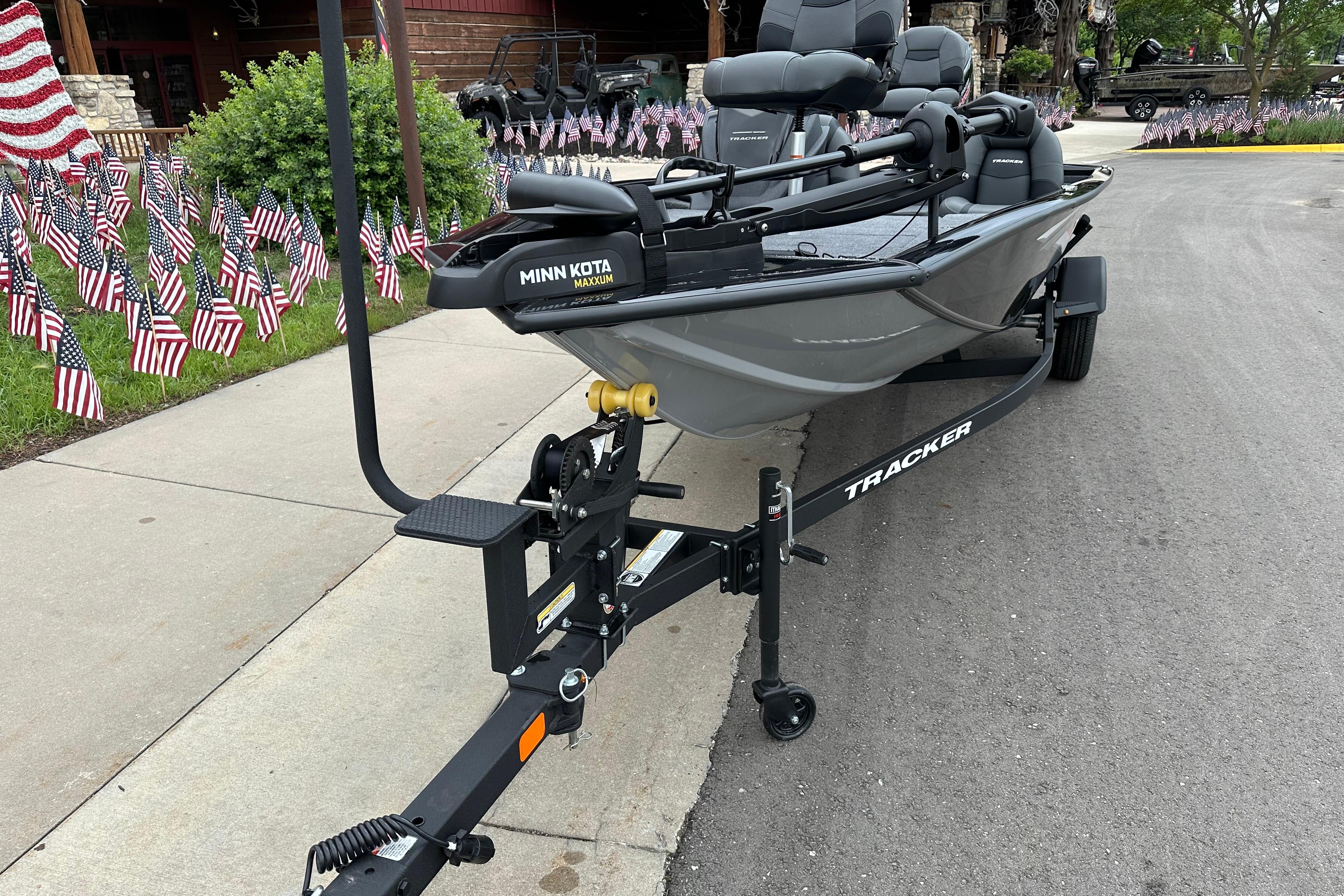 2026 Tracker Pro Team 190 boat on trailer, surrounded by American flags.