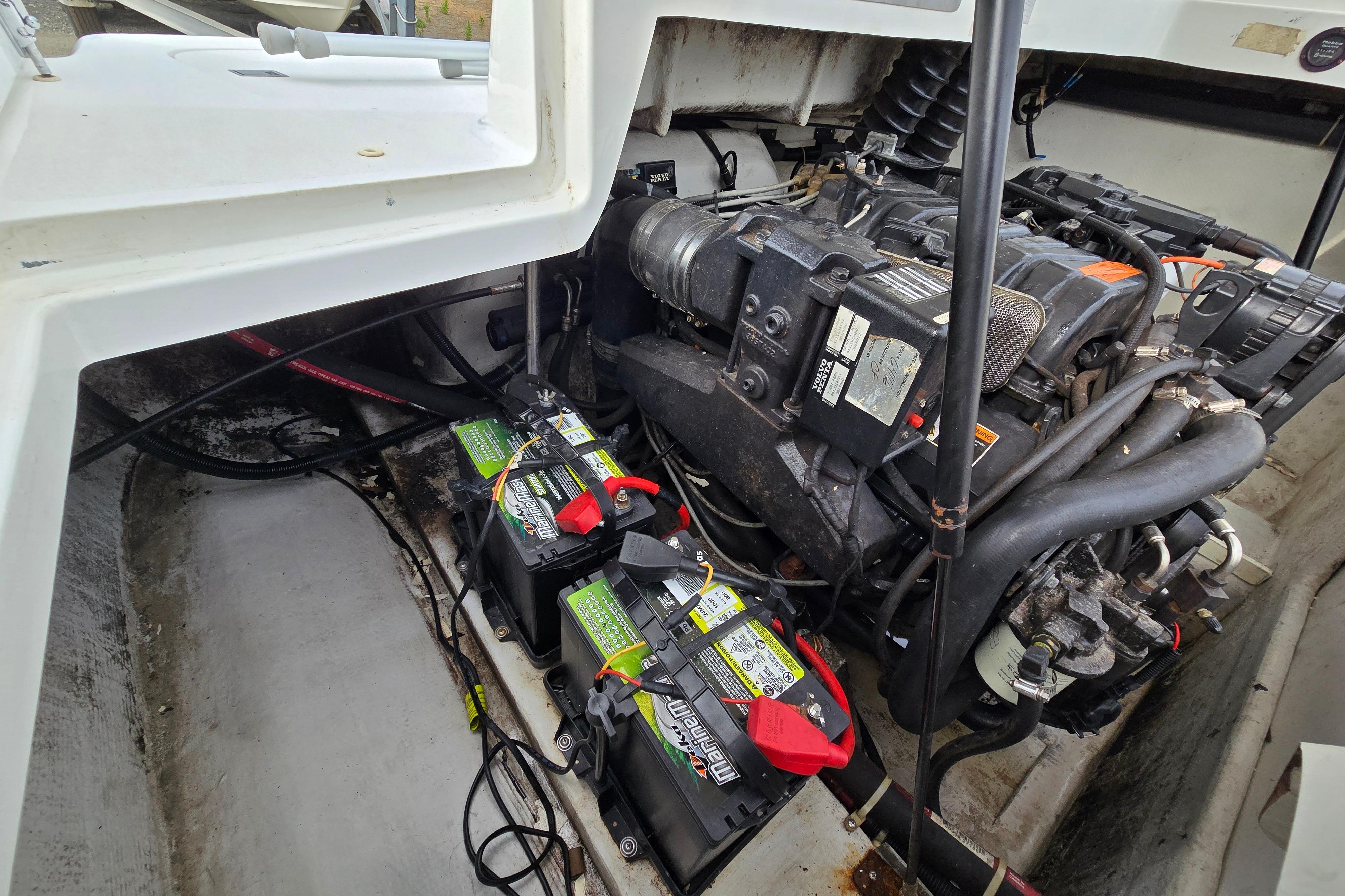 Engine compartment of a 2000 Cobalt 246 boat with visible batteries and wiring.