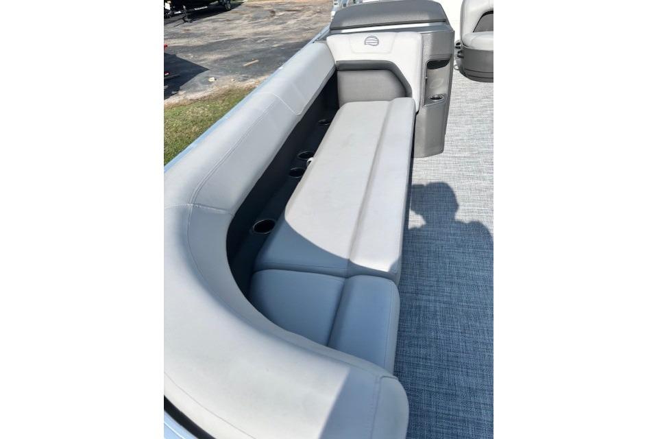 2026 Sun Tracker Party Barge 18 DLX interior with gray seating and cup holders.