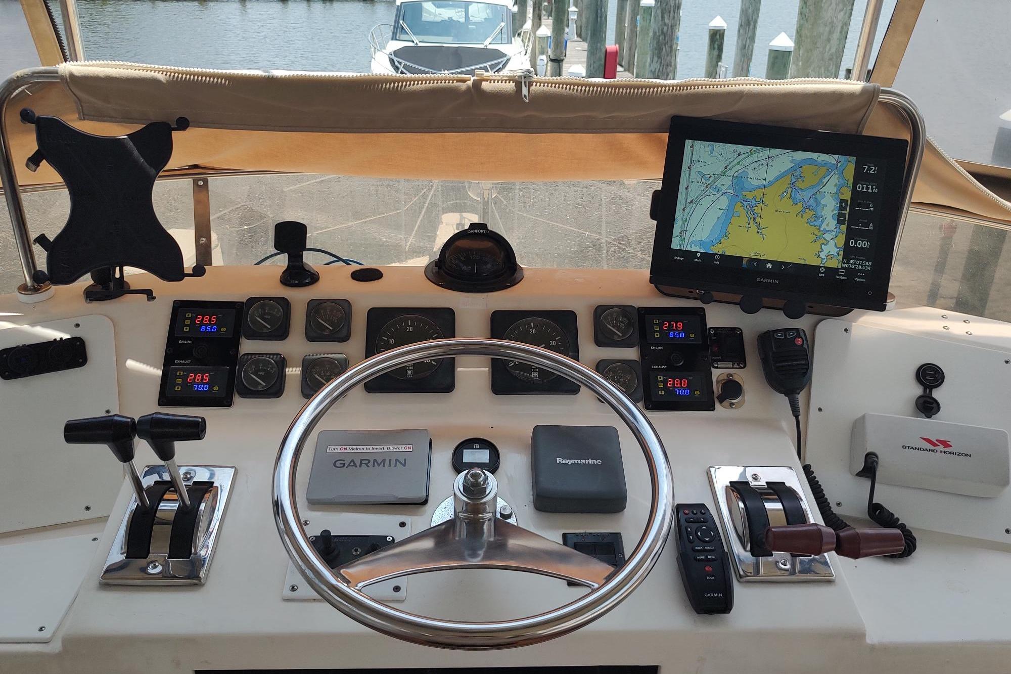 Helm of 1989 Hyatt Double Cabin Motoryacht with navigation equipment and steering wheel.
