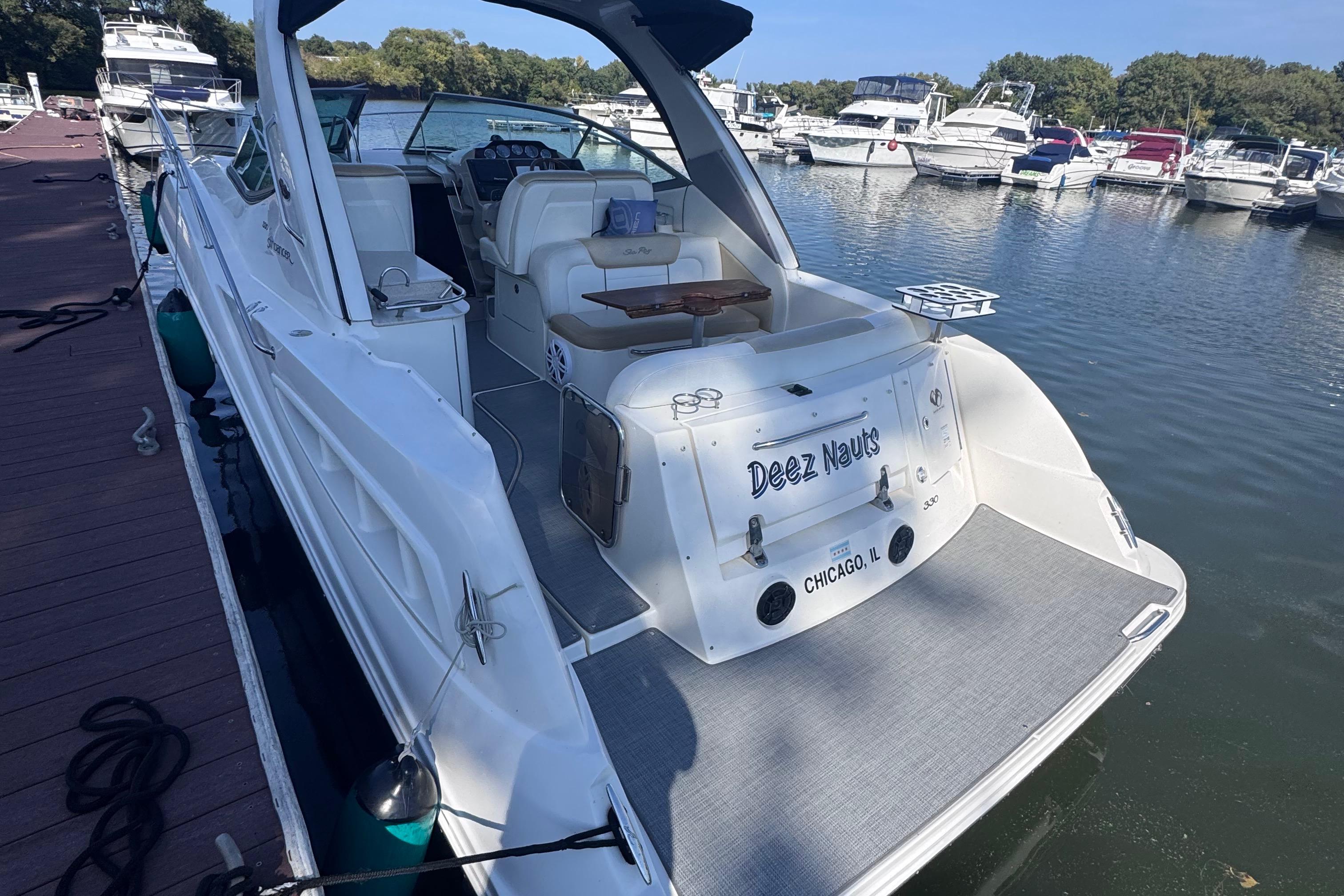 2008 Sea Ray 350 Sundancer docked at marina, rear view with seating area.