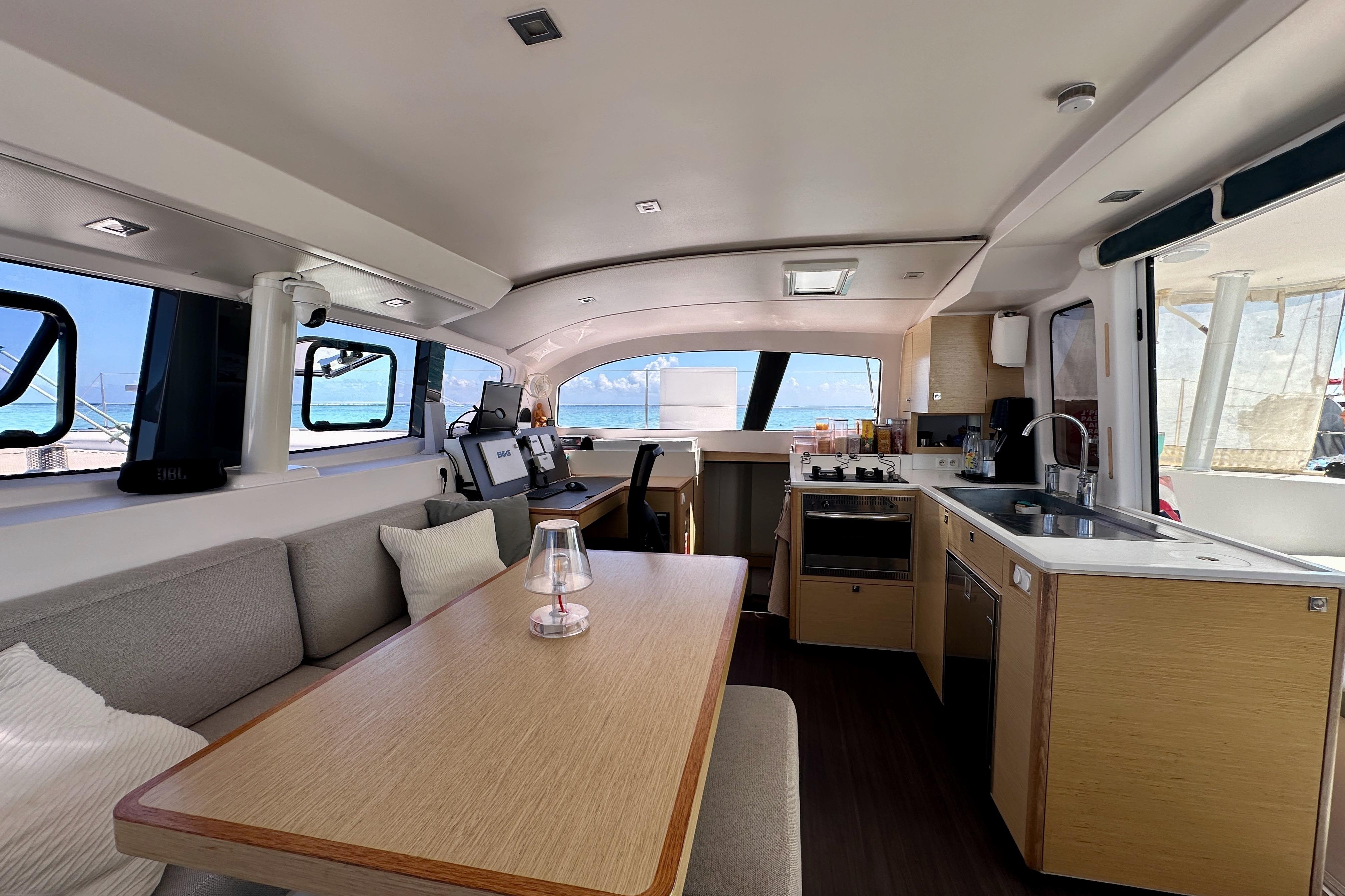 Interior of 2019 Outremer 45 catamaran with modern kitchen and dining area.