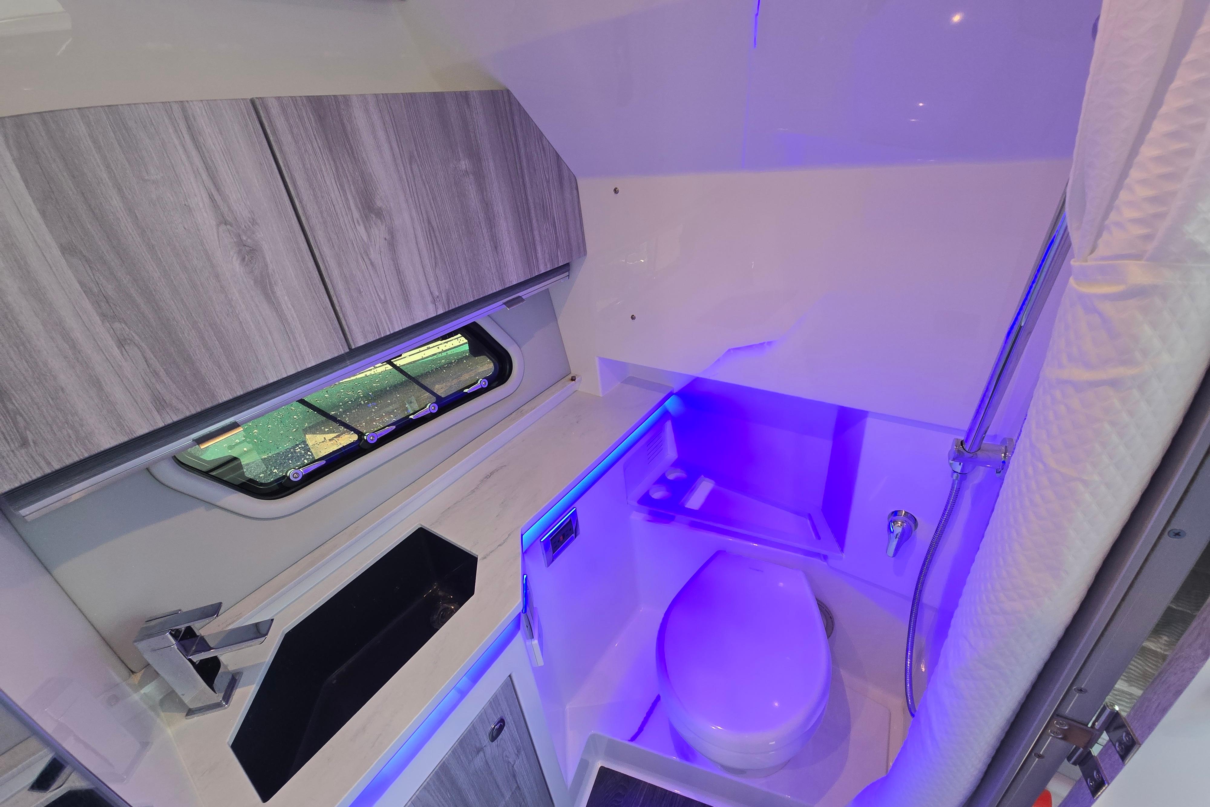 2025 Formula 380 Super Sport Crossover OB bathroom with modern fixtures and ambient lighting.