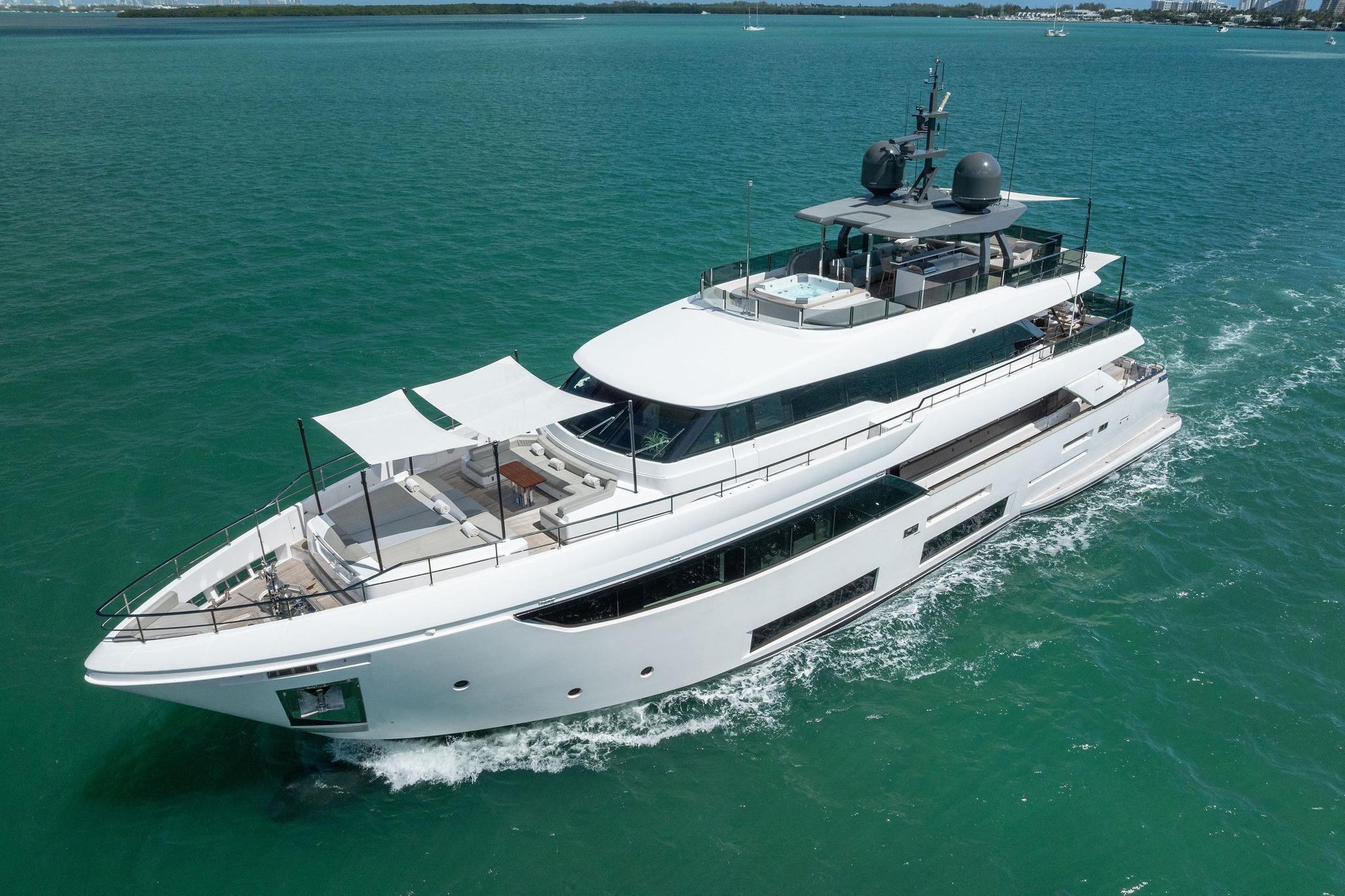 Luxurious 2023 Custom Line Navetta 33 yacht cruising on clear blue waters.