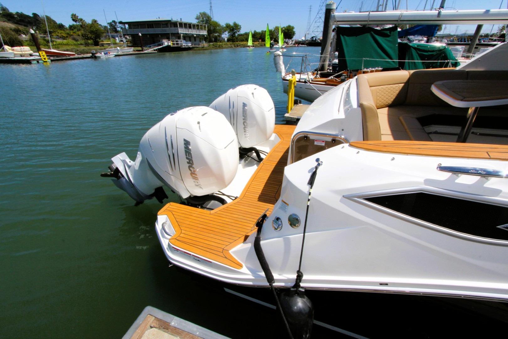 2021 Sea Ray Sundancer 320 Outboard with twin Mercury engines docked at marina.