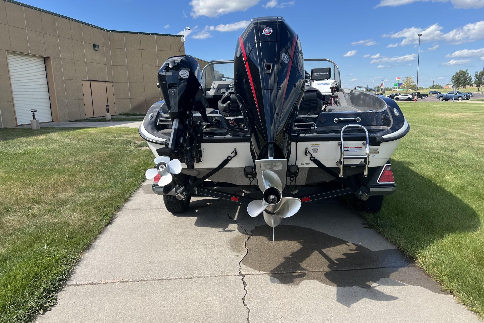 2023 Ranger 620FS Cup-Equipped boat with dual outboard motors on a sunny day.