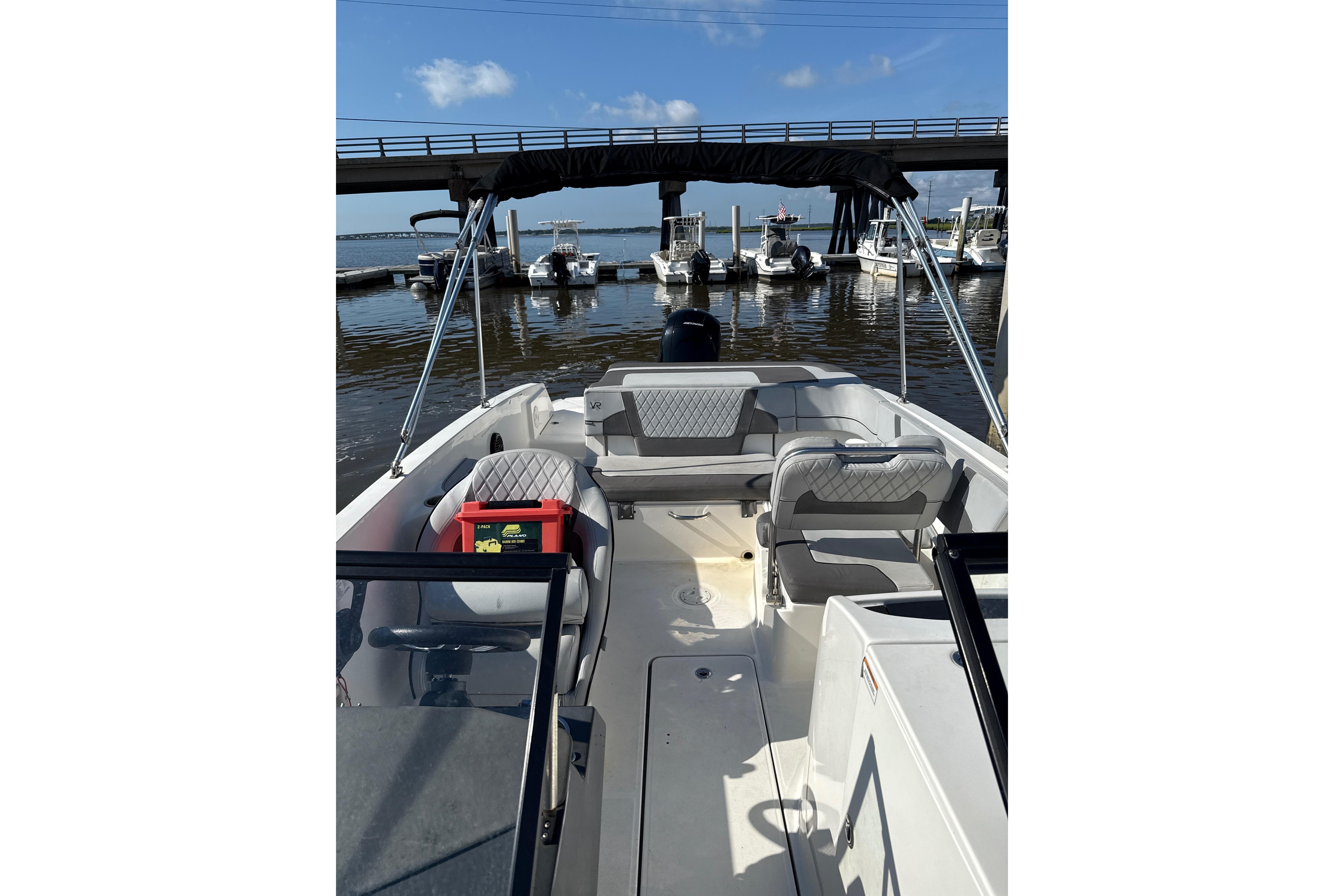 2023 Bayliner VR6 Bowrider OB at marina, featuring spacious seating and sleek design.