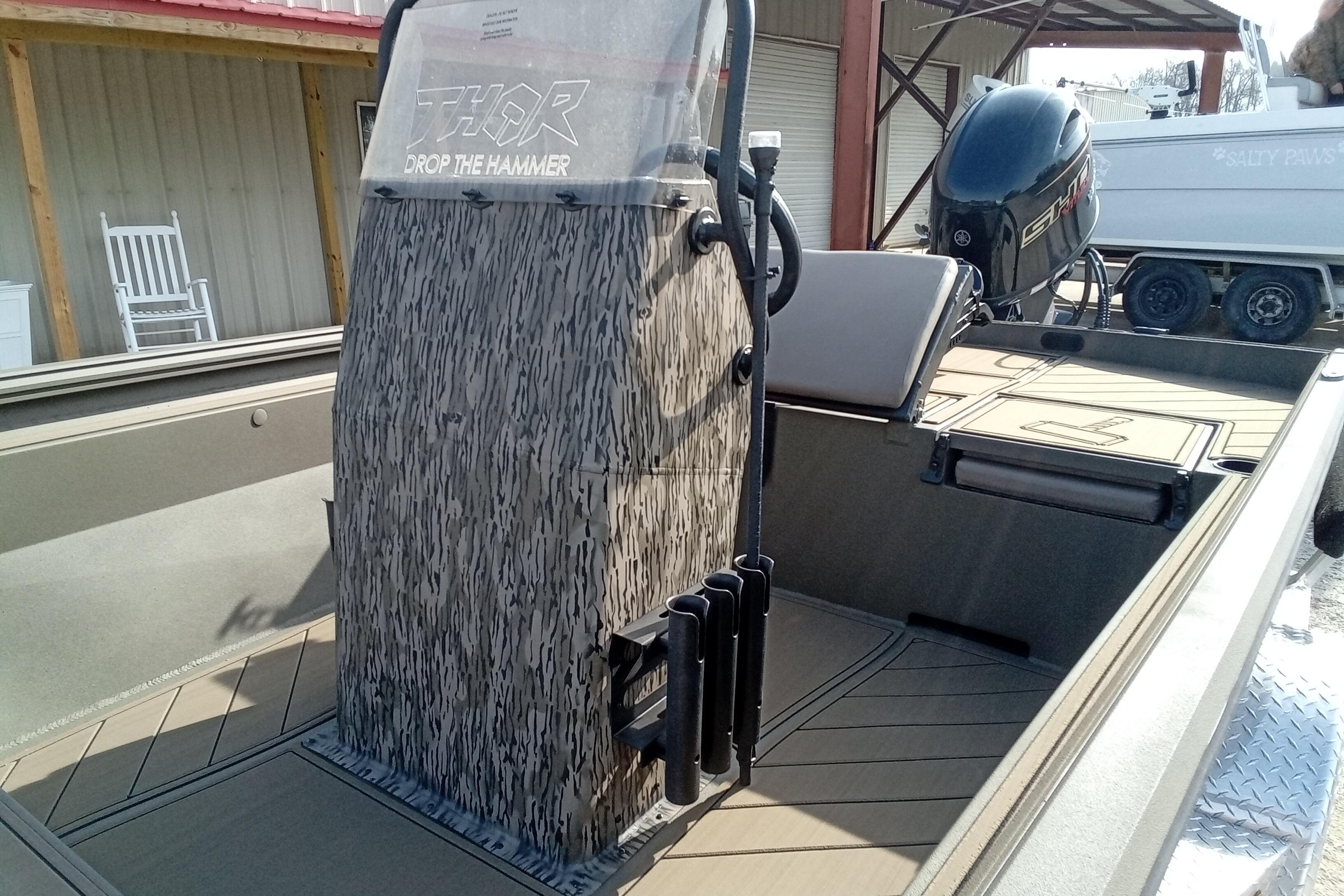 2026 Thor 1900 Low Country Elite boat with camo console and outboard motor.