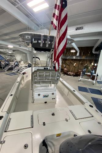 2024 Key West 250 Bay Reef boat in showroom with American flag.