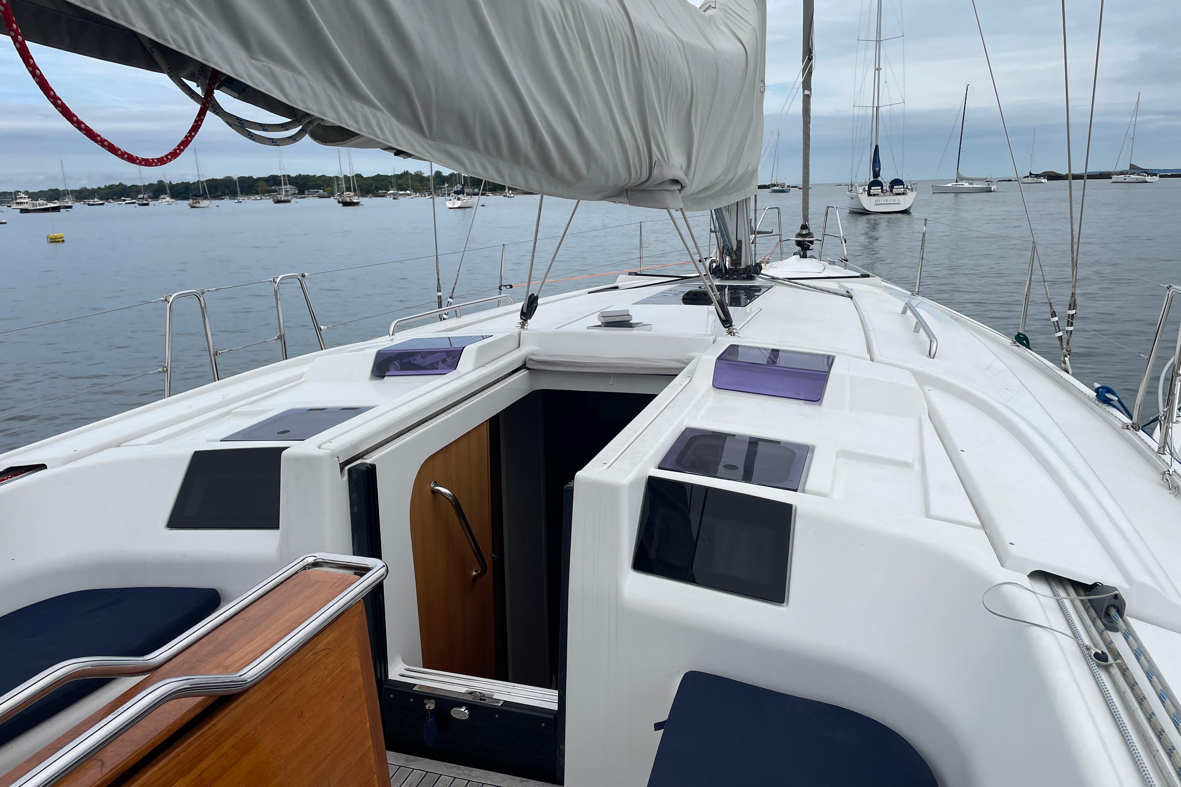 Sailing yacht Hanse 415, 2014 model, docked in a serene marina setting.