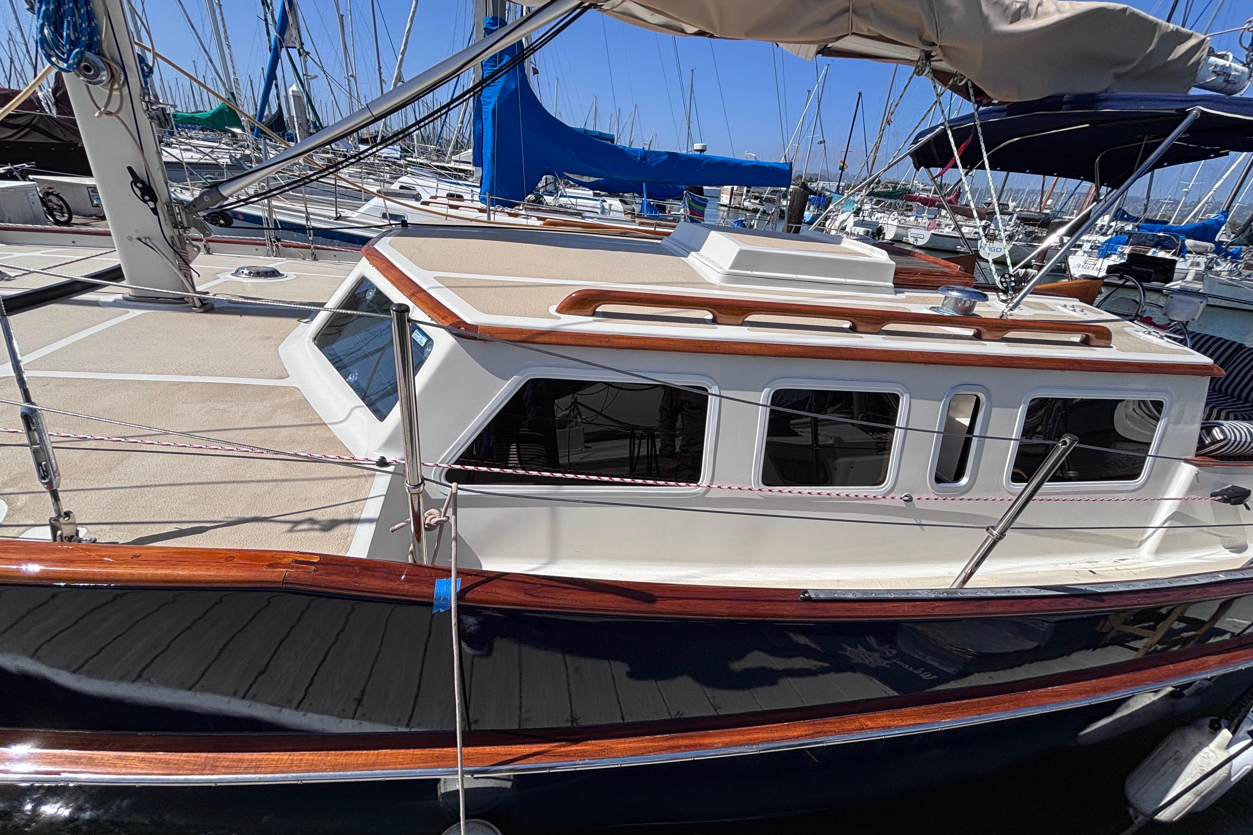 1978 Swift 33 sailboat docked at a marina, showcasing classic design and wooden accents.