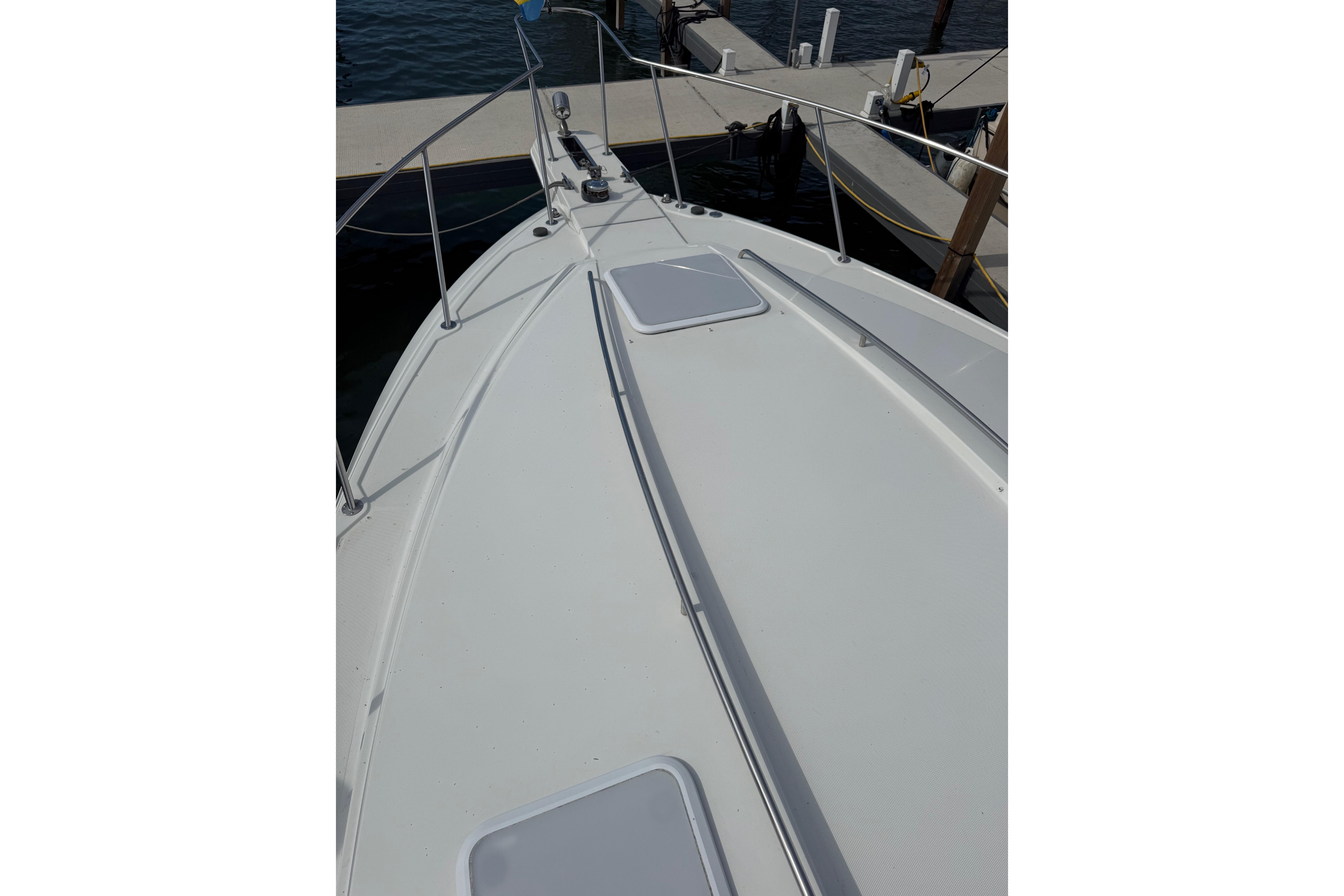 1999 Formula 34 Performance Cruiser docked, showing sleek deck design and marina setting.