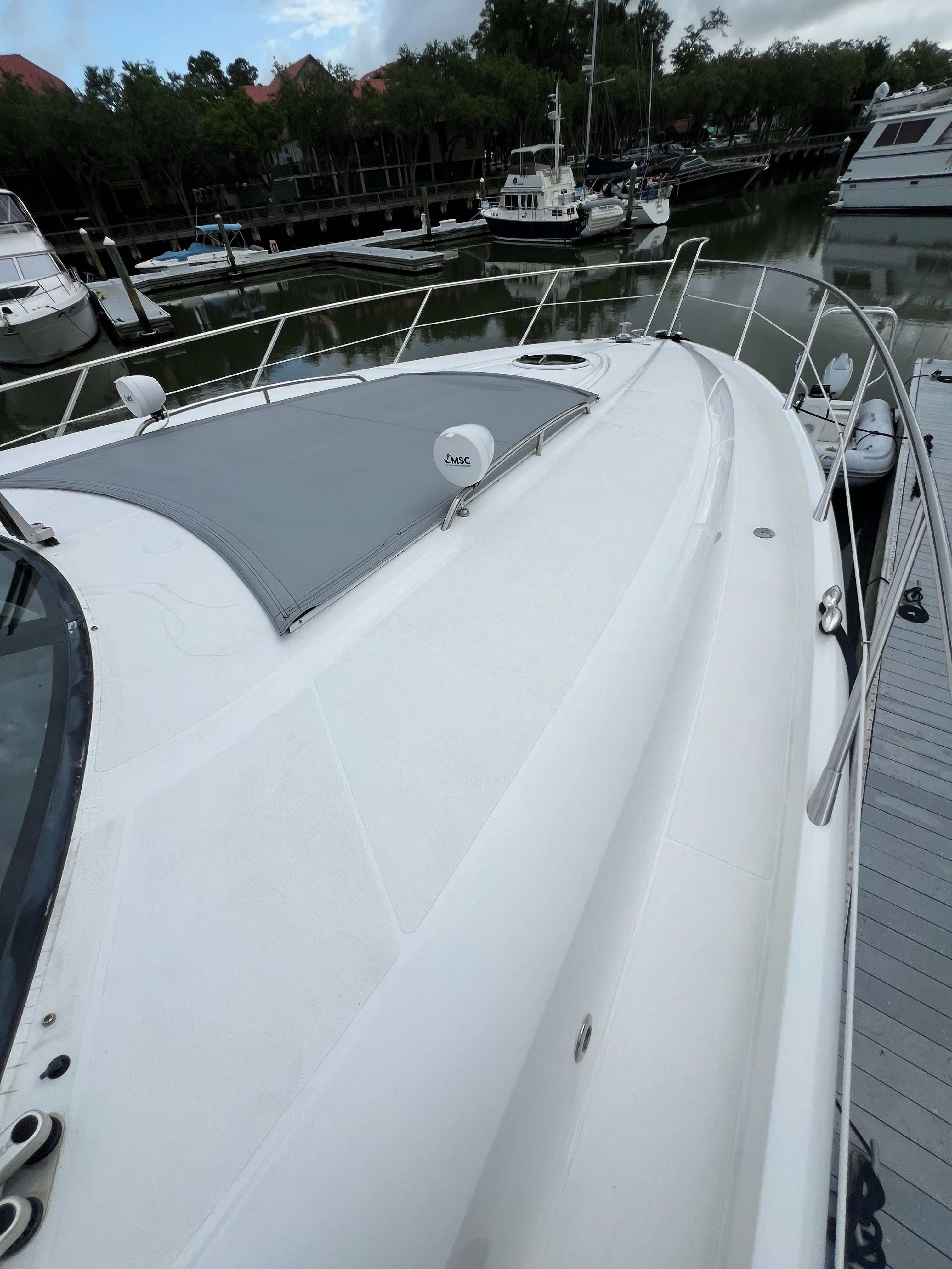 2008 Sunseeker Predator 62 yacht docked at marina.