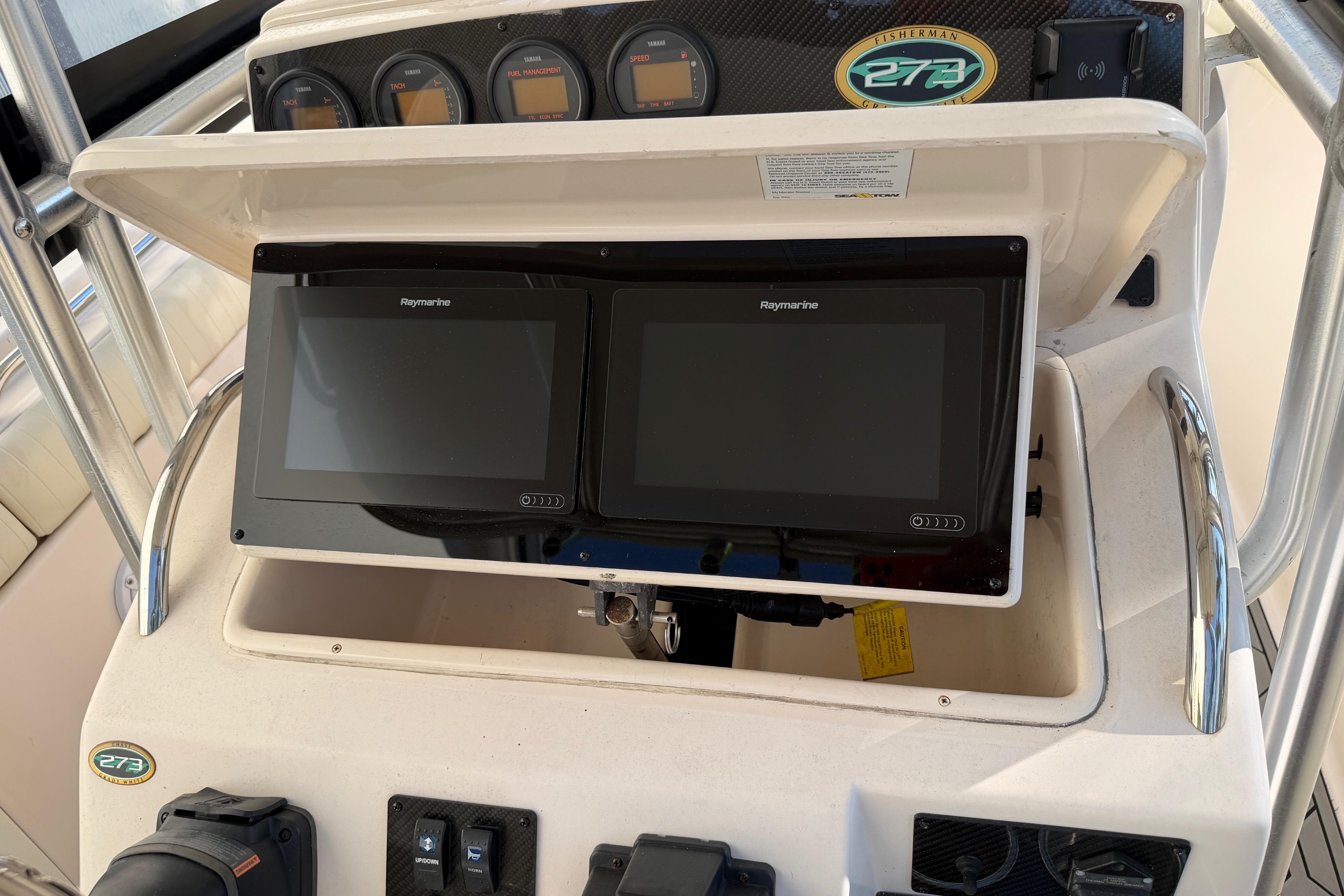 2004 Grady White 273 boat dashboard with Raymarine displays and gauges.