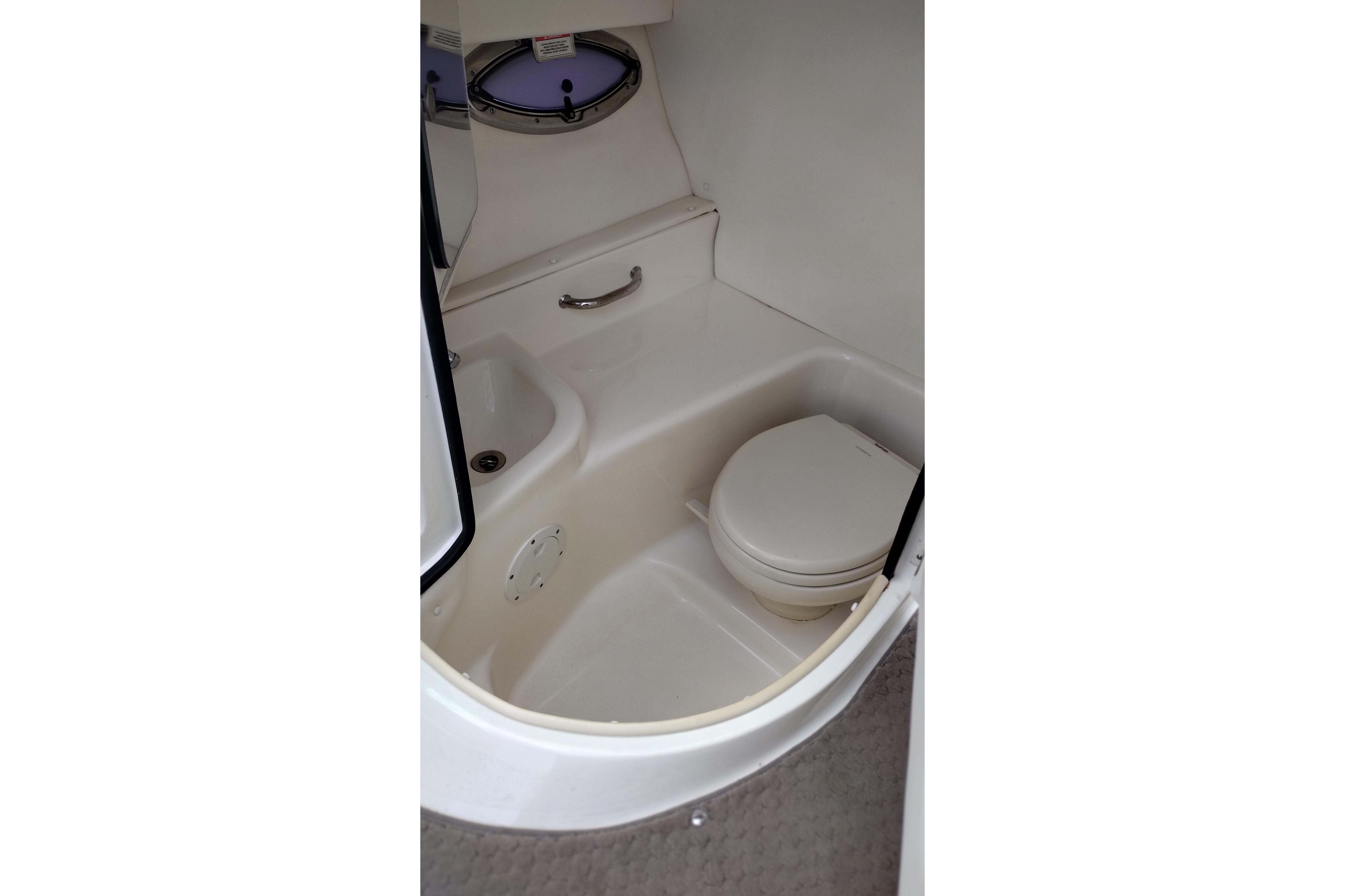 2013 Sea Ray 300 SLX boat interior with compact marine toilet.