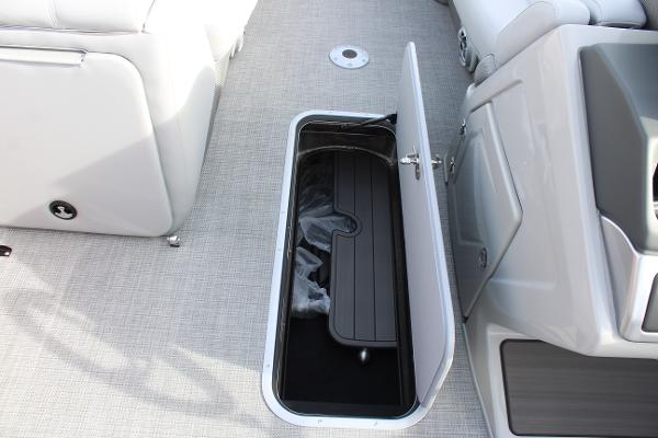 Open storage compartment on 2025 Regency 230 DL3 boat interior.