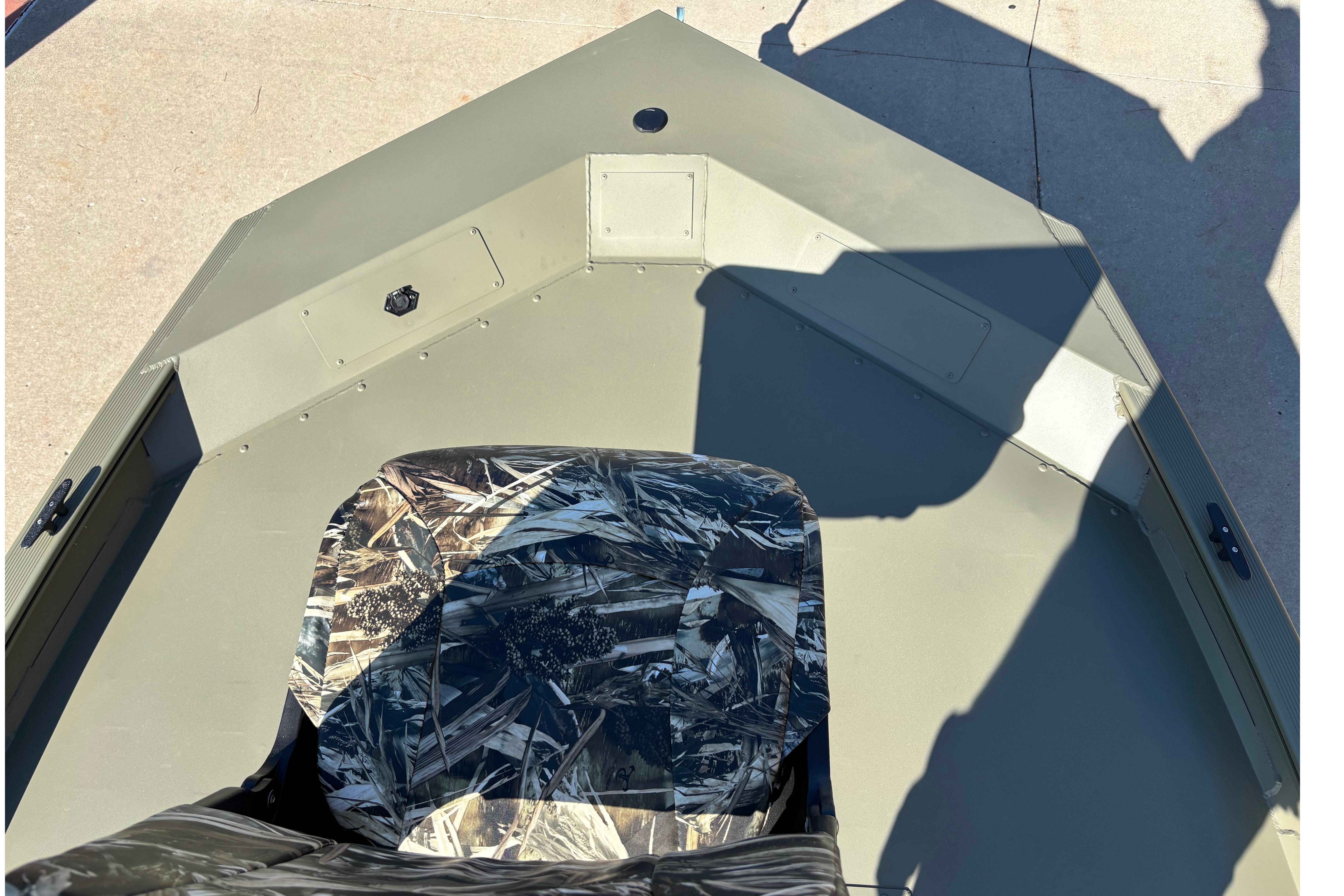 2026 Tracker Grizzly 1754 SC boat interior with camouflage seat and spacious deck.