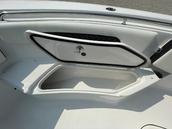 2025 Tidewater 232 CC Adventure boat storage compartment open, showcasing interior space.