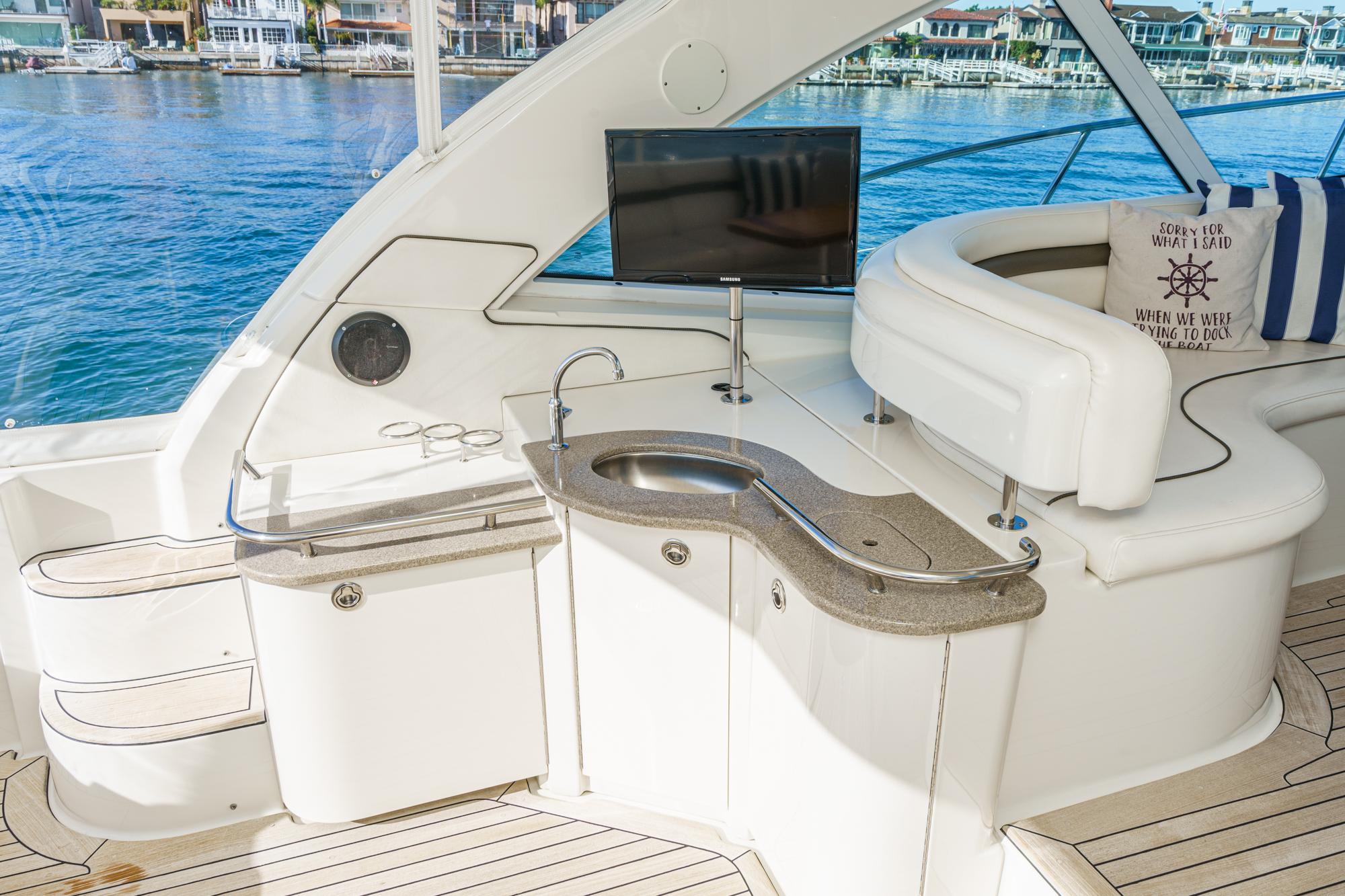 Luxurious interior of 2005 Sea Ray 480 Sundancer with bar and TV.