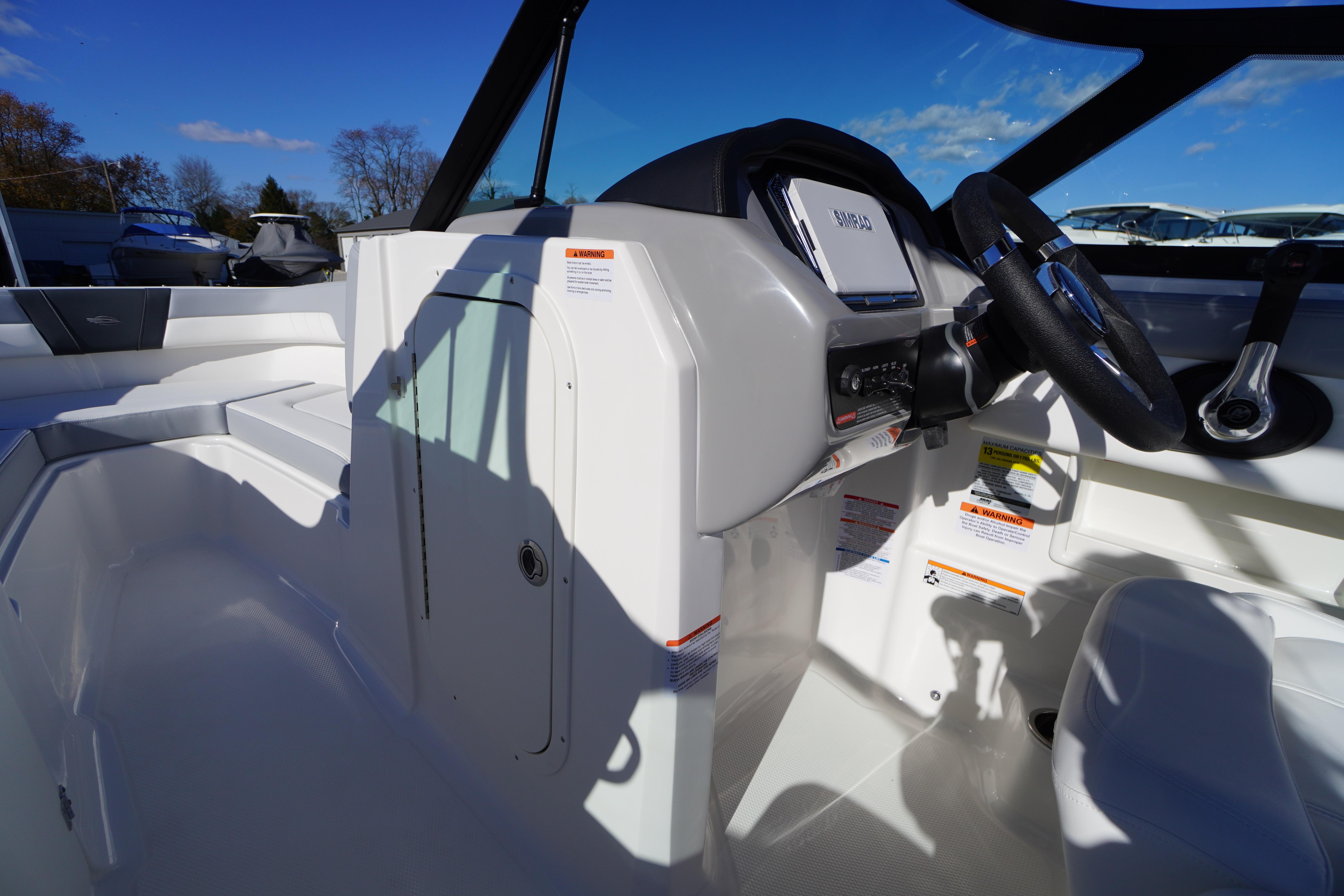2026 Chaparral 23 SSi boat interior with steering wheel and control panel.