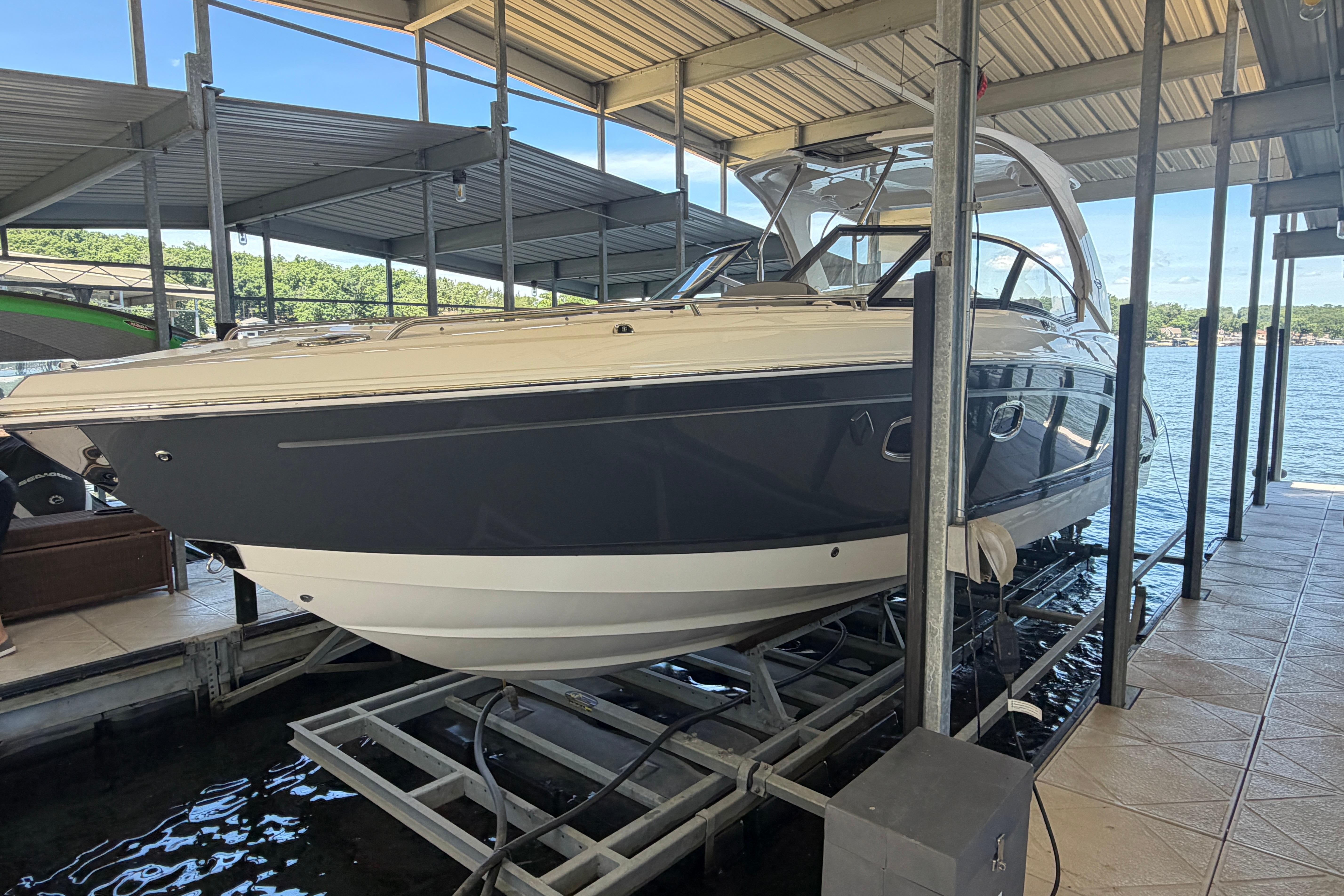 2018 Chaparral 347 SSX boat docked in a covered marina.