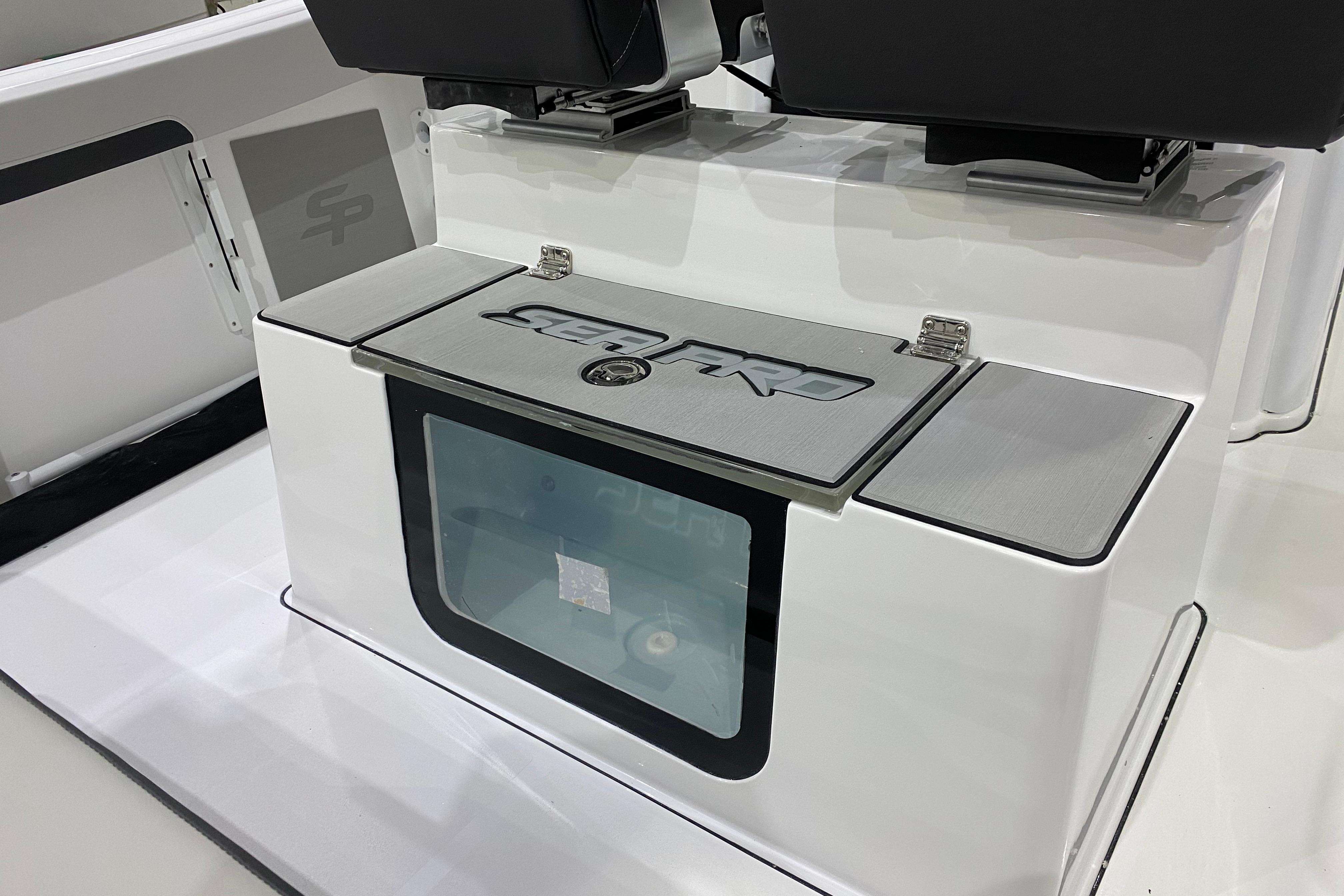 2027 Sea Pro 245FLXR Sandbar boat interior with storage compartment and seating.