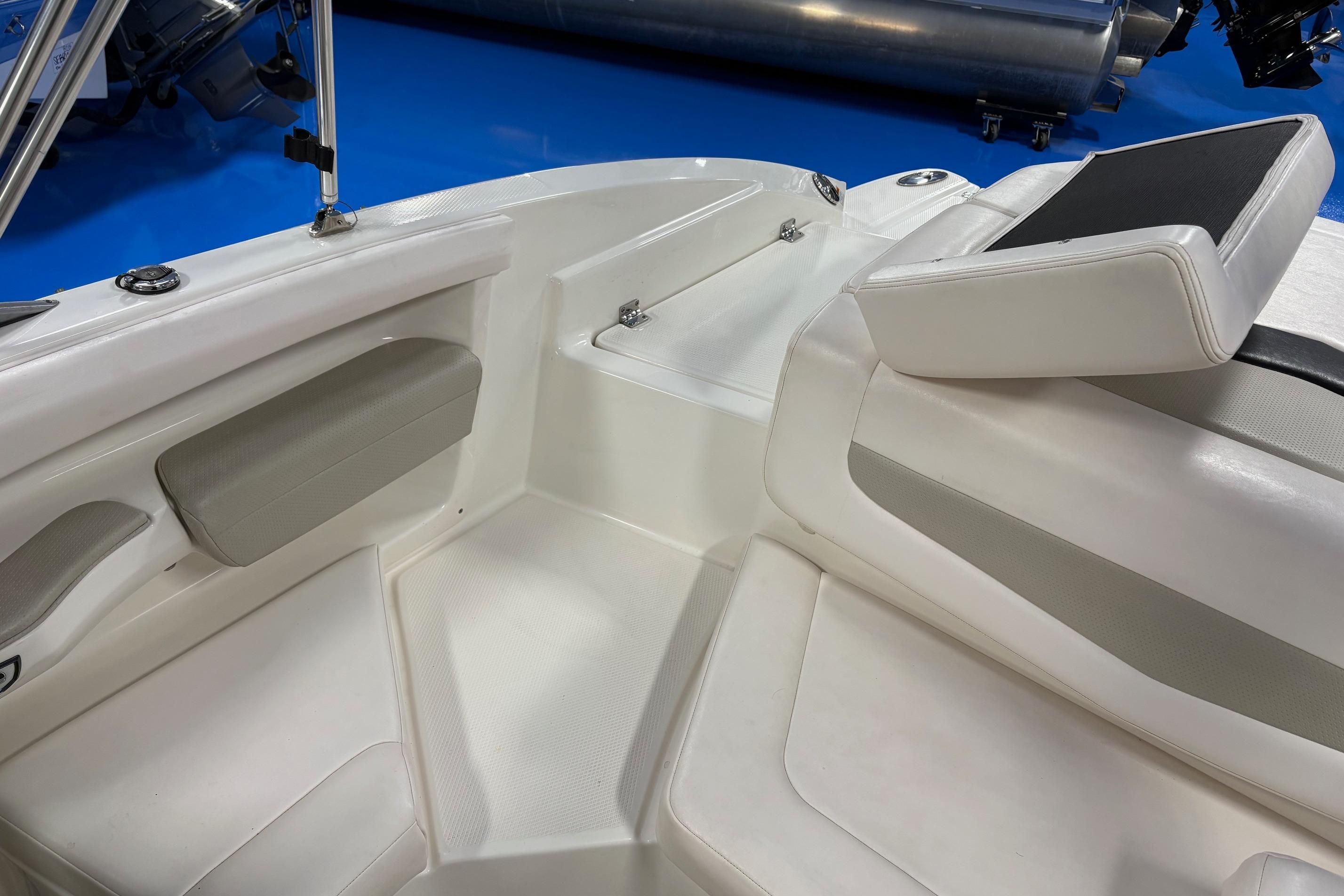 Interior view of a 2011 Chaparral 216 SSi boat, featuring white seating and sleek design.