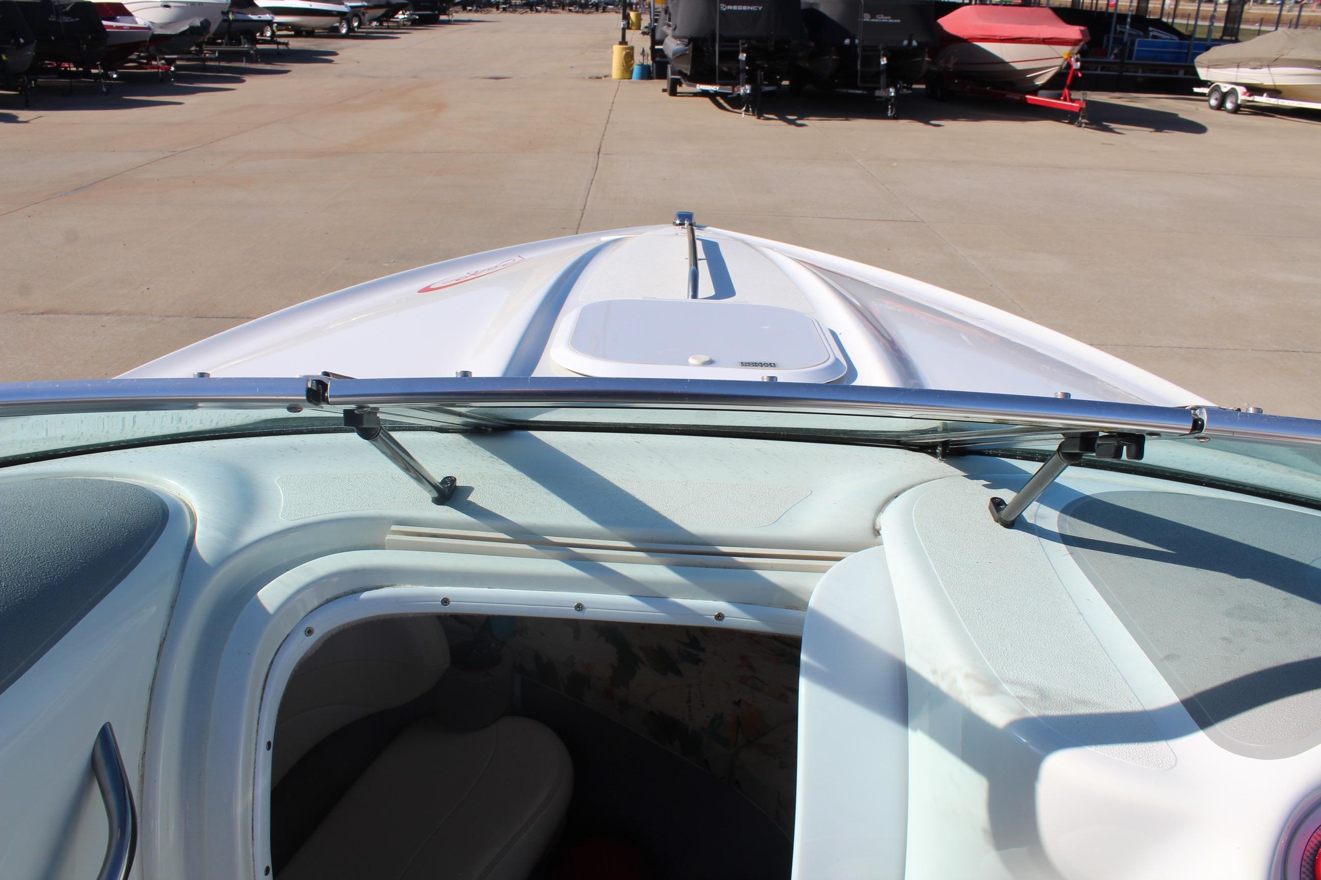 1996 Baja 232 boat interior view with open cabin hatch.