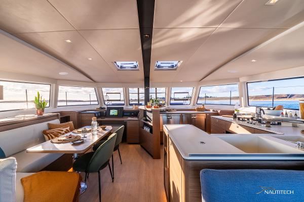 Luxurious interior of 2025 Nautitech 48 Open catamaran with modern dining and kitchen area.