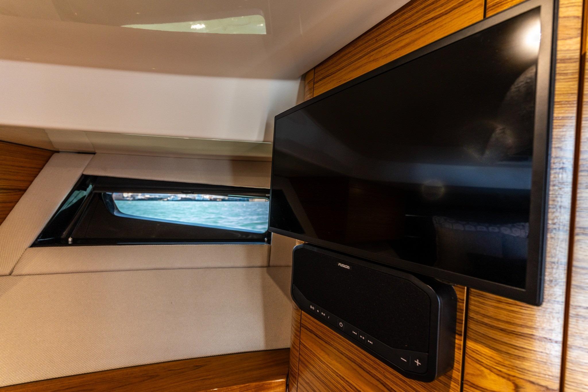 Interior of 2023 Boston Whaler 405 Conquest with TV and window view.