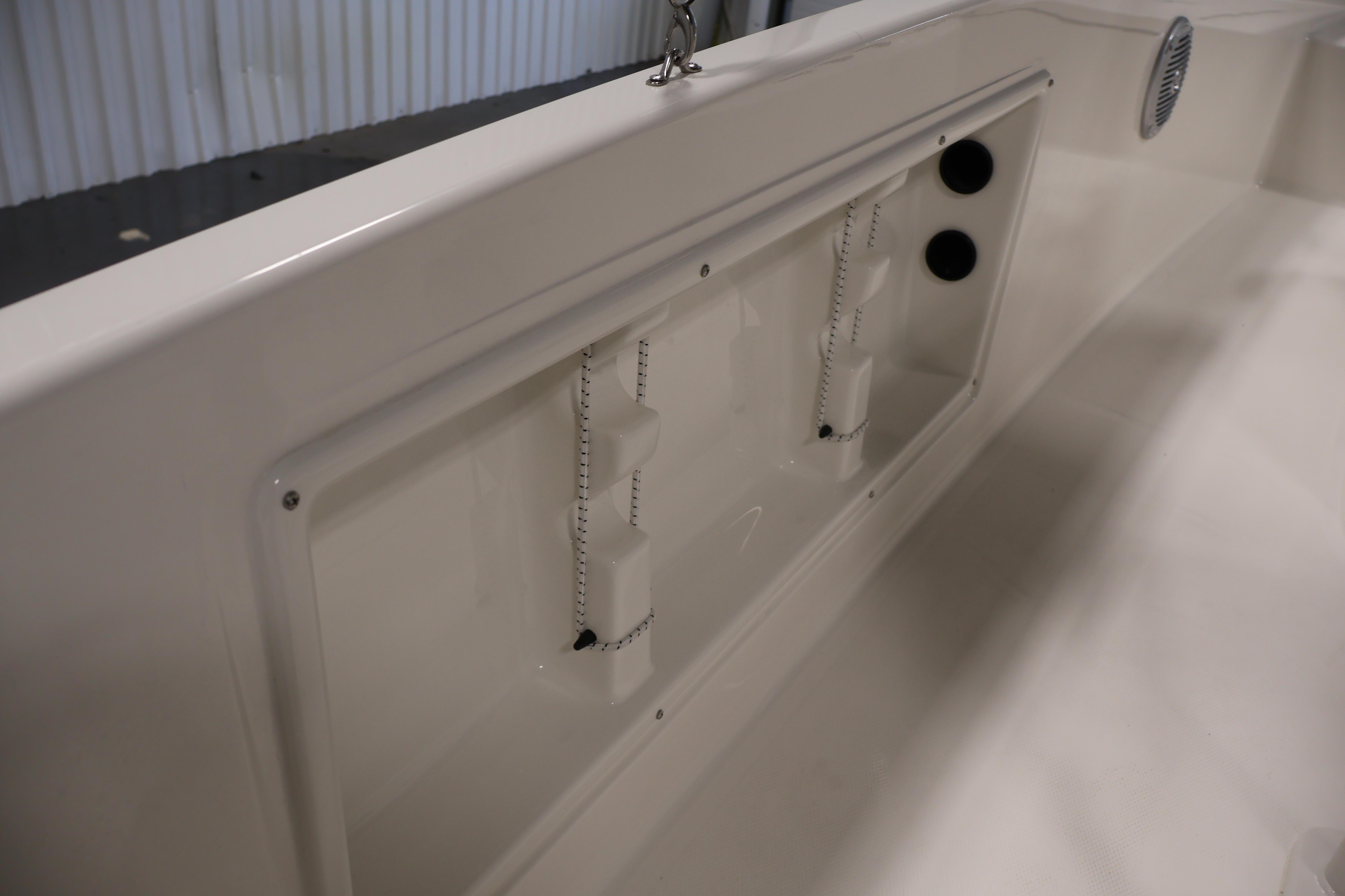 2026 Bayliner Trophy T18 boat interior detail with storage compartment and speaker.