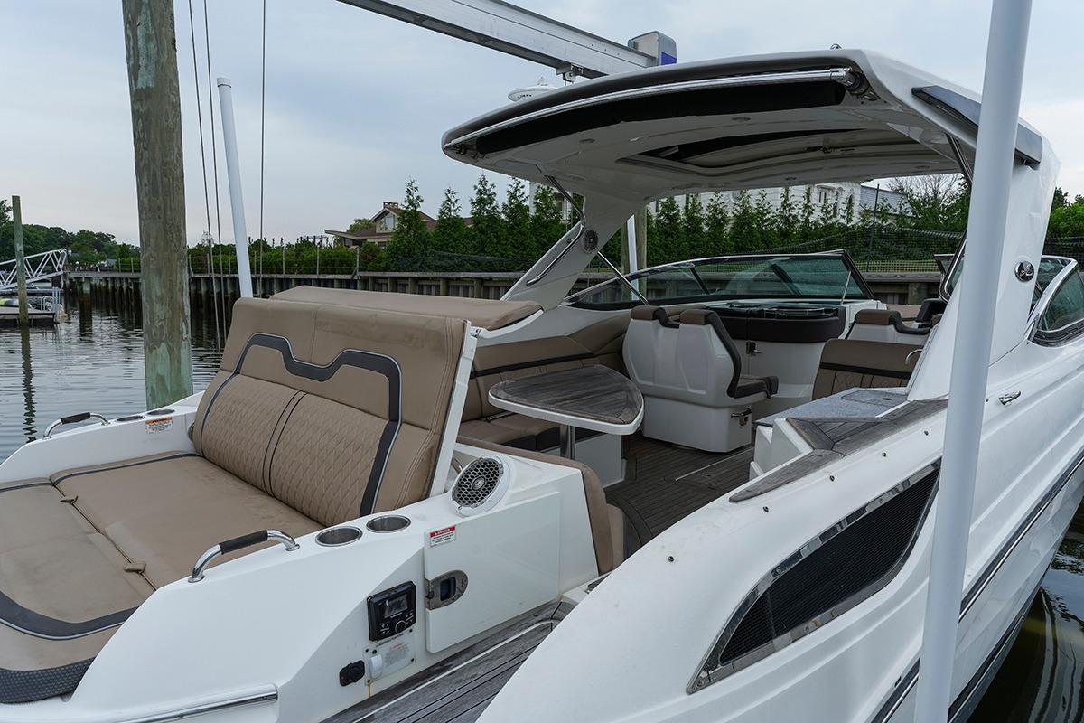 2018 Sea Ray SLX 350 boat with spacious seating and sleek design docked at marina.