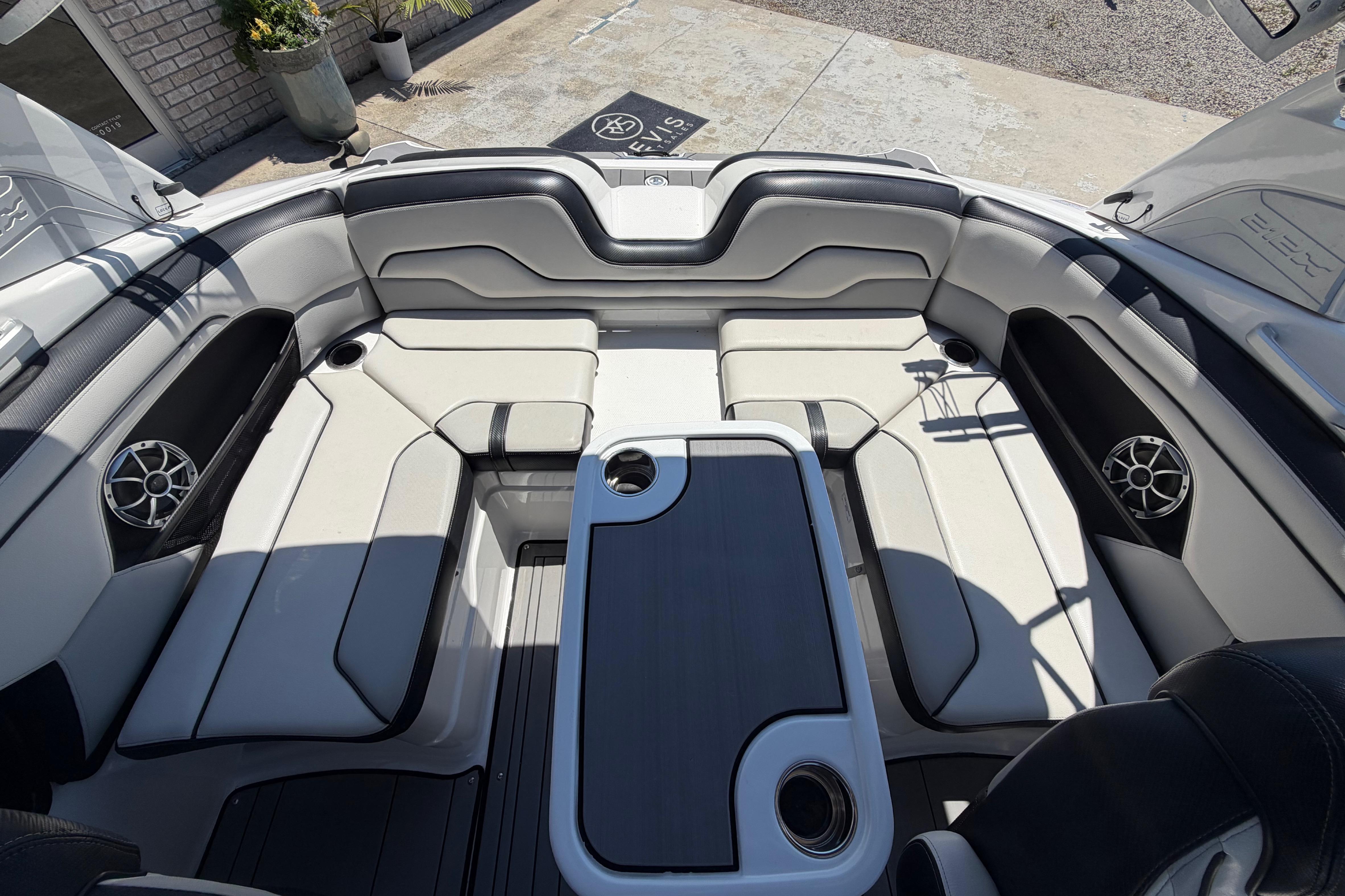 Interior of 2019 Yamaha Boats 212X, featuring sleek seating and integrated speakers.
