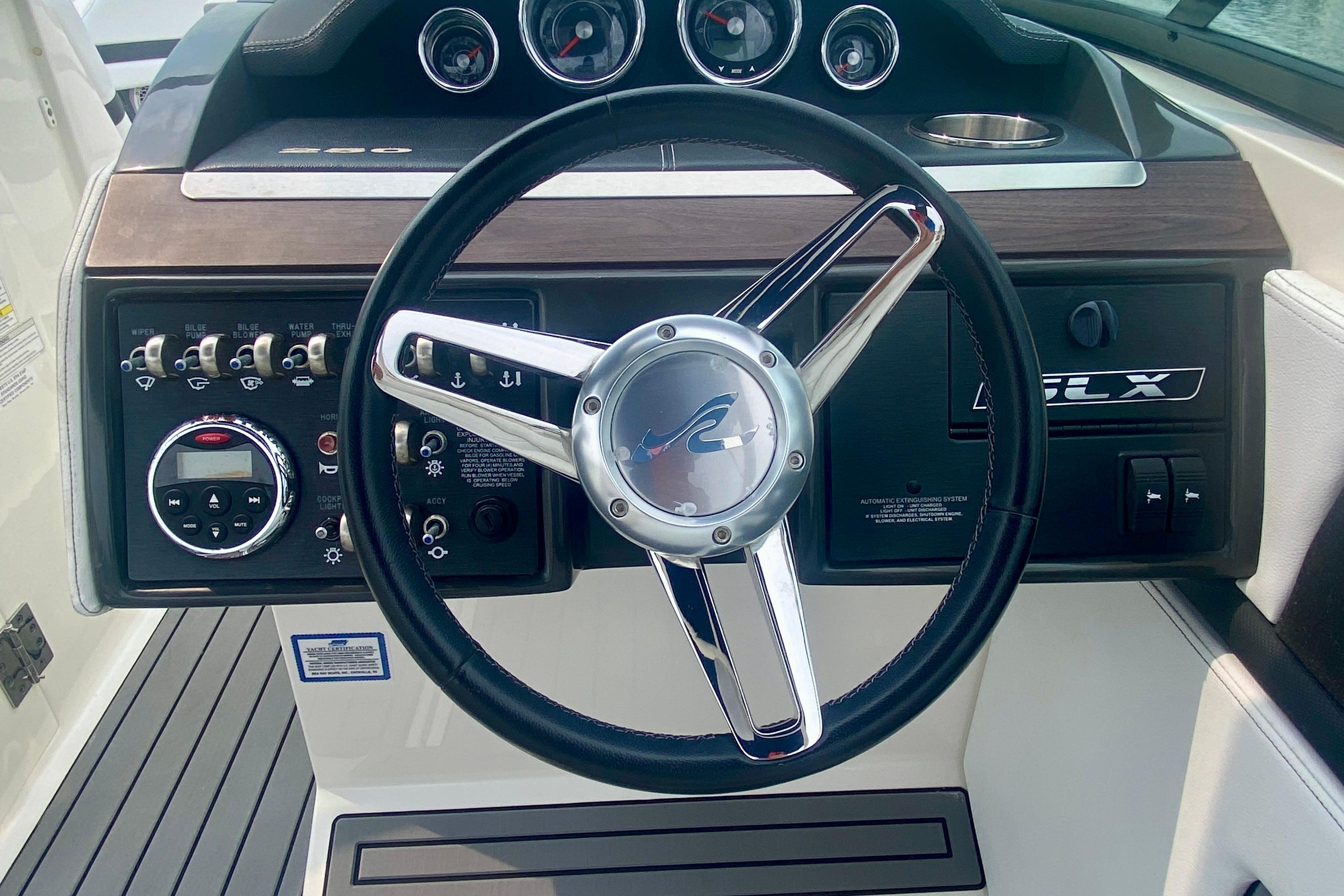 Steering wheel and dashboard of 2015 Sea Ray 250 SLX boat.