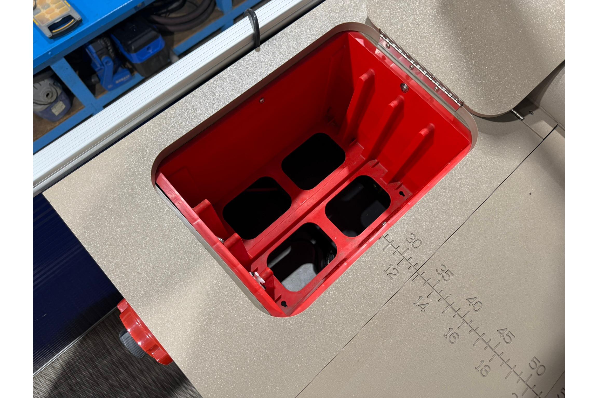 Red compartment on a 2020 Bennington SX 22 SFX boat, featuring measurement markings.